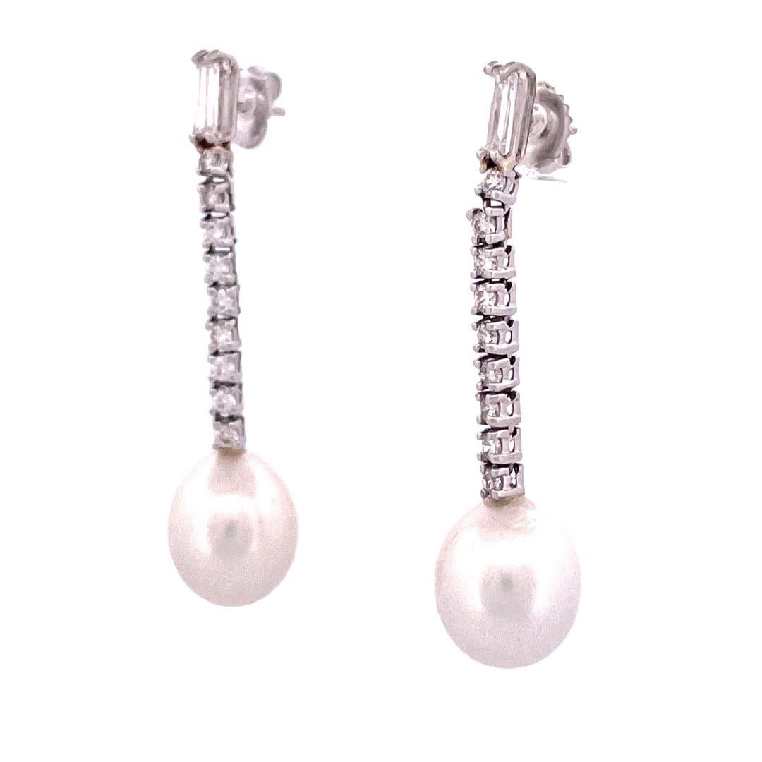 Elegant 14k White Gold Diamond and Pearl Dangle Earrings

Adorn yourself with timeless beauty through these exquisite 14k white gold dangle earrings. At the heart of each earring rests a lustrous, large pearl.The pearls are gracefully accompanied by