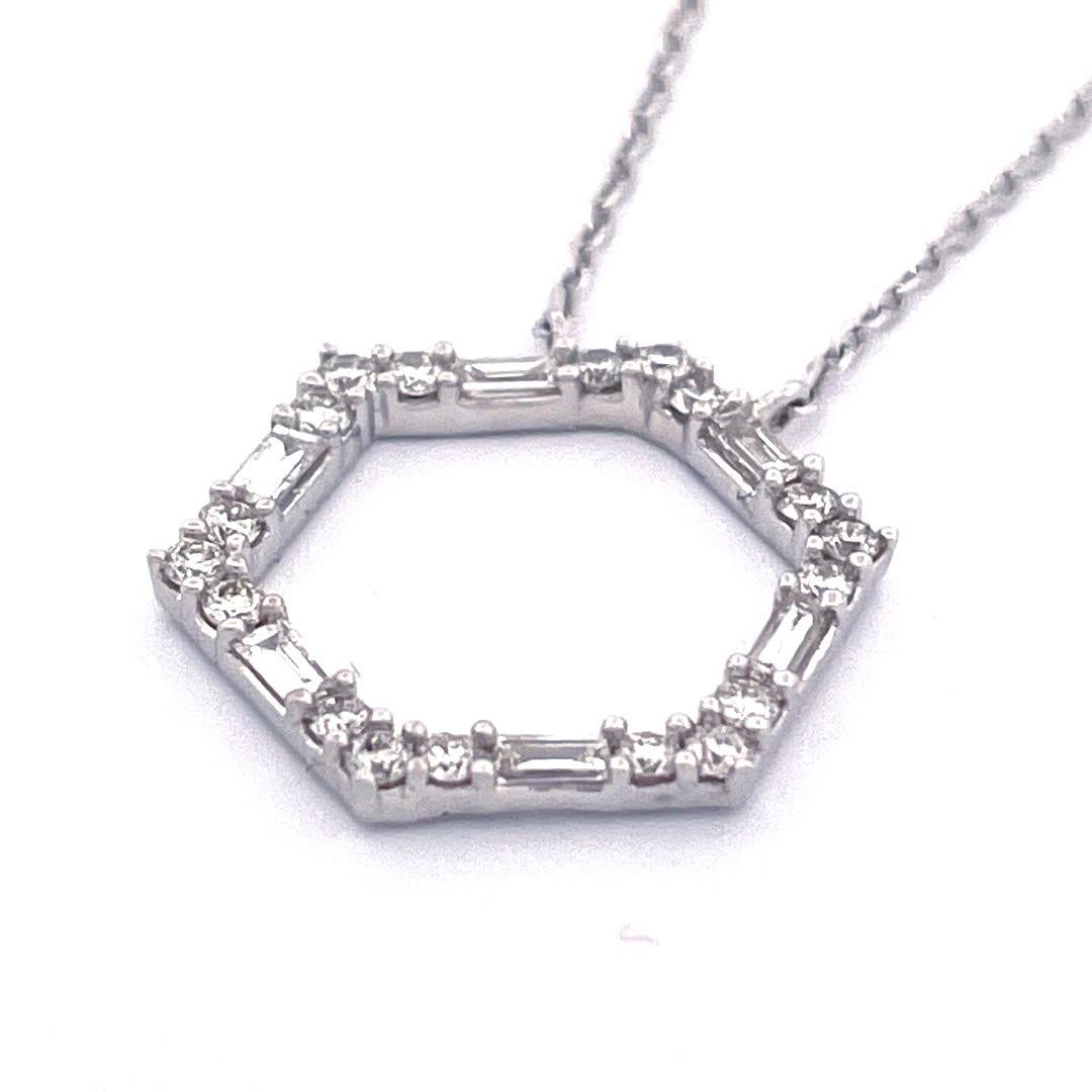 Elegant 14k White Gold Hexagonal Diamond Pendant Necklace

Adorn yourself with the elegant charm of our 14k white gold hexagonal diamond pendant necklace. The pendant showcases a dazzling array of mix-cut diamonds, totaling 0.35 carats.With a weight