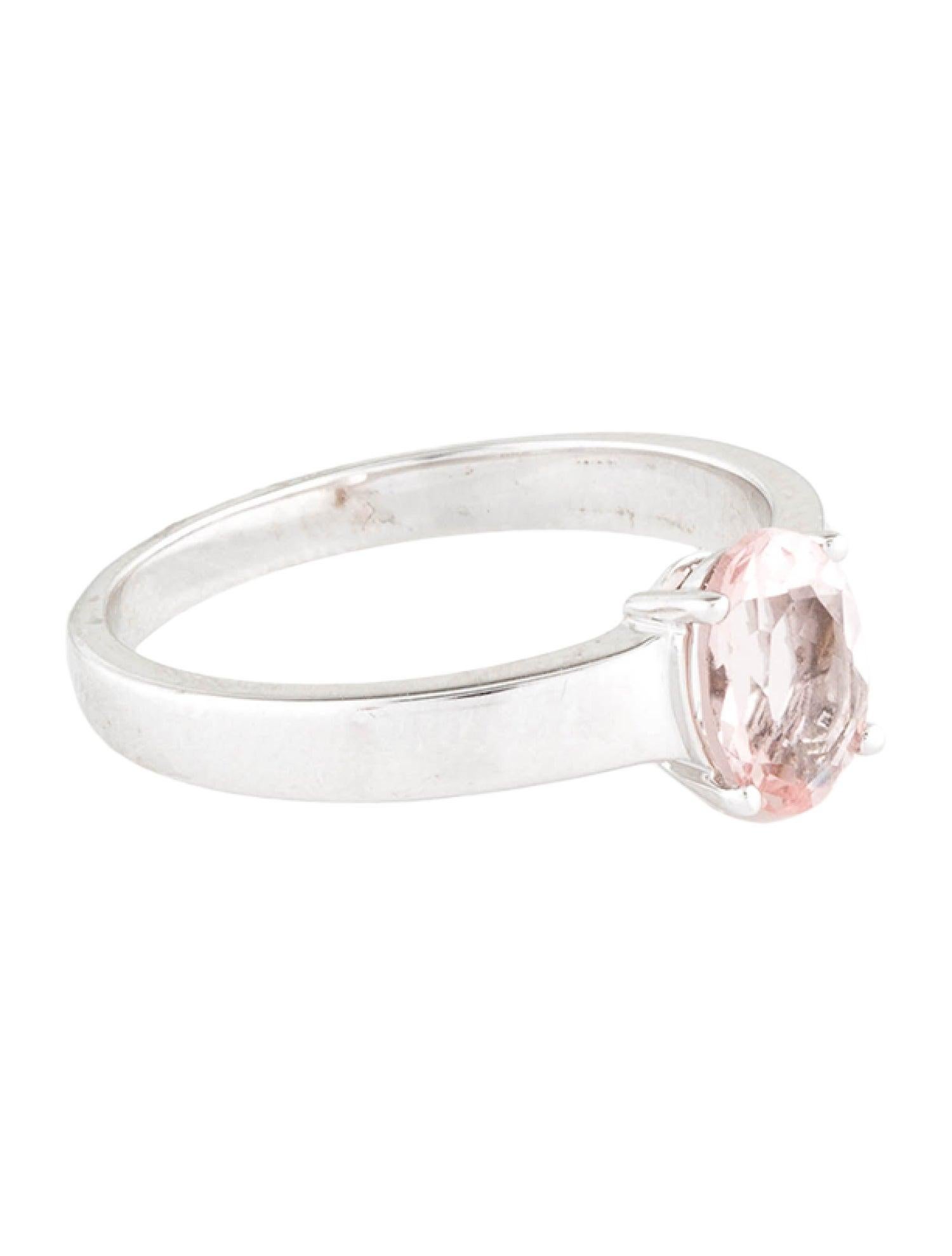 Unveil the essence of grace and elegance with our exquisite Rhodium-Plated 14K White Gold Cocktail Ring, featuring a mesmerizing 0.99 Carat Oval Morganite. This sophisticated piece, sized at 7.75, is a testament to timeless beauty and luxury. The