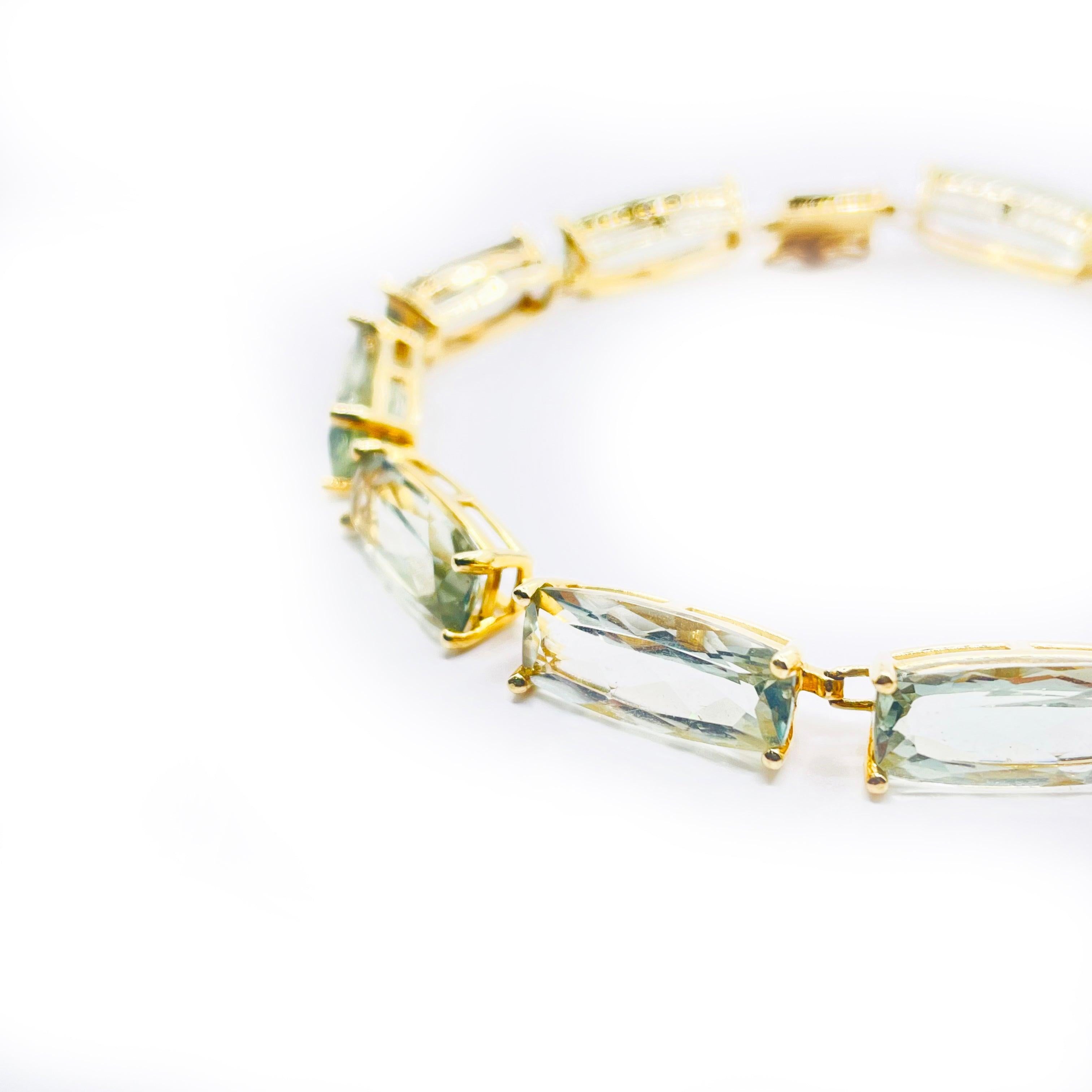 Adorn your wrist with the exquisite beauty of this
14k yellow gold bracelet weighing 11.5G featuring a
greenish topaz adds a unique touch to this piece, 
making it stand out from traditional gold bracelets.
