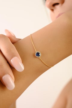 Elegante Pulsera de Oro Amarillo de 14K con Cadena Halo de Zafiro Azul de Corte Ovalado y Diamantes