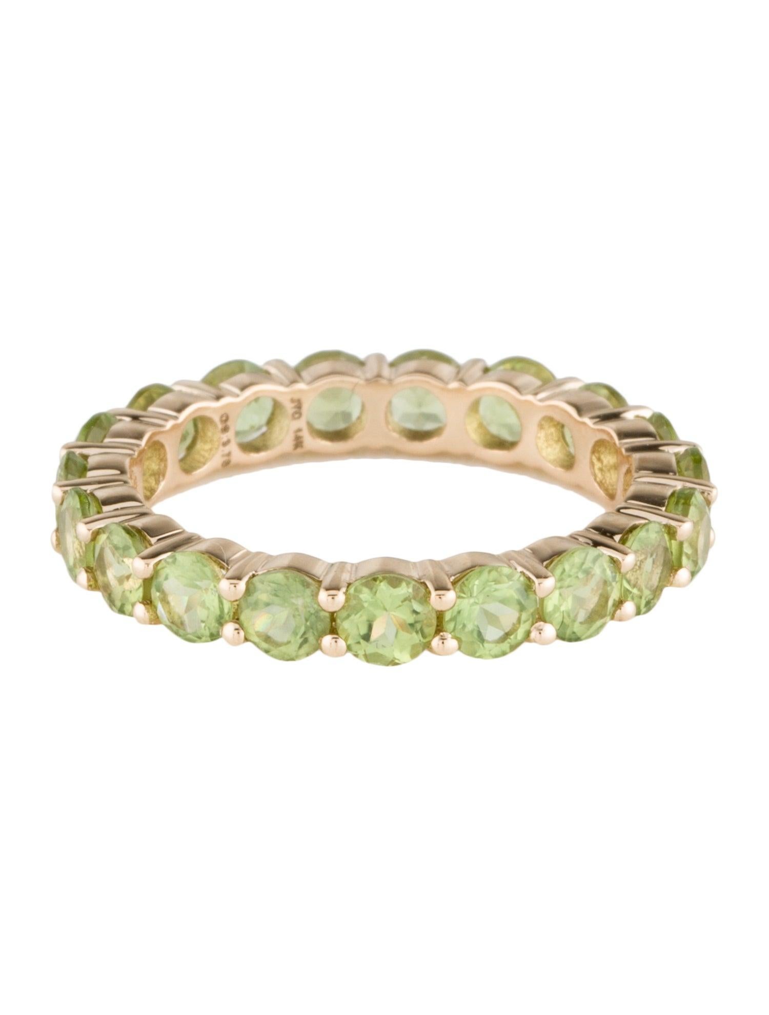 Embrace timeless elegance with our 14K Yellow Gold Eternity Band, adorned with nineteen faceted round Peridots, each exuding a vibrant green hue. This exquisite band captures the essence of eternal beauty, symbolized by the continuous circle of
