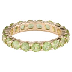 Elegant 14K Yellow Gold Peridot Eternity Band with Faceted Round Peridots