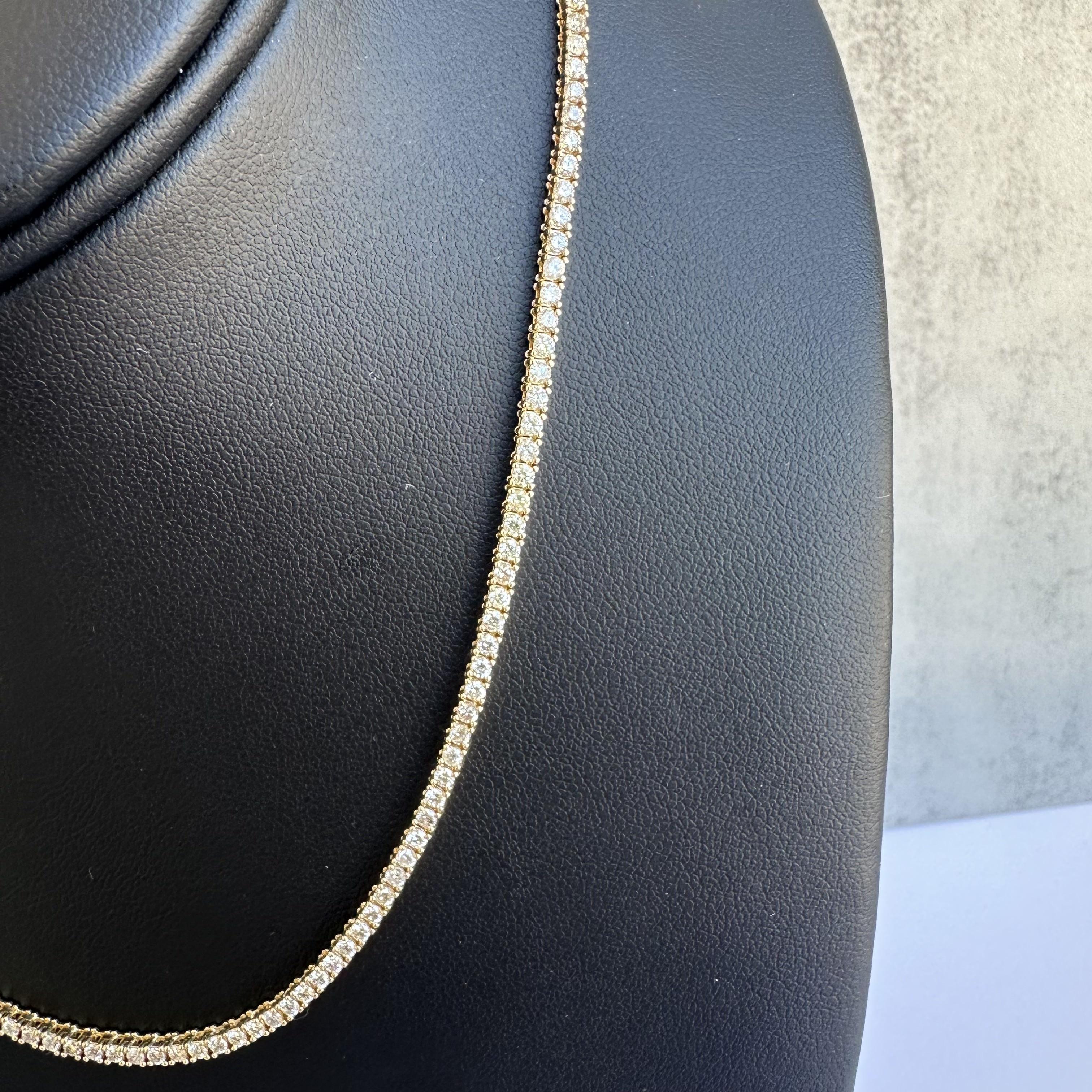 Introducing our breathtaking 14kt Yellow Gold Diamond Tennis Necklace:
A masterpiece of luxury and precision. This exquisite piece features 4.50 carats of GH color, SI2-I1 clarity natural diamonds, meticulously set in a classic straight line tennis