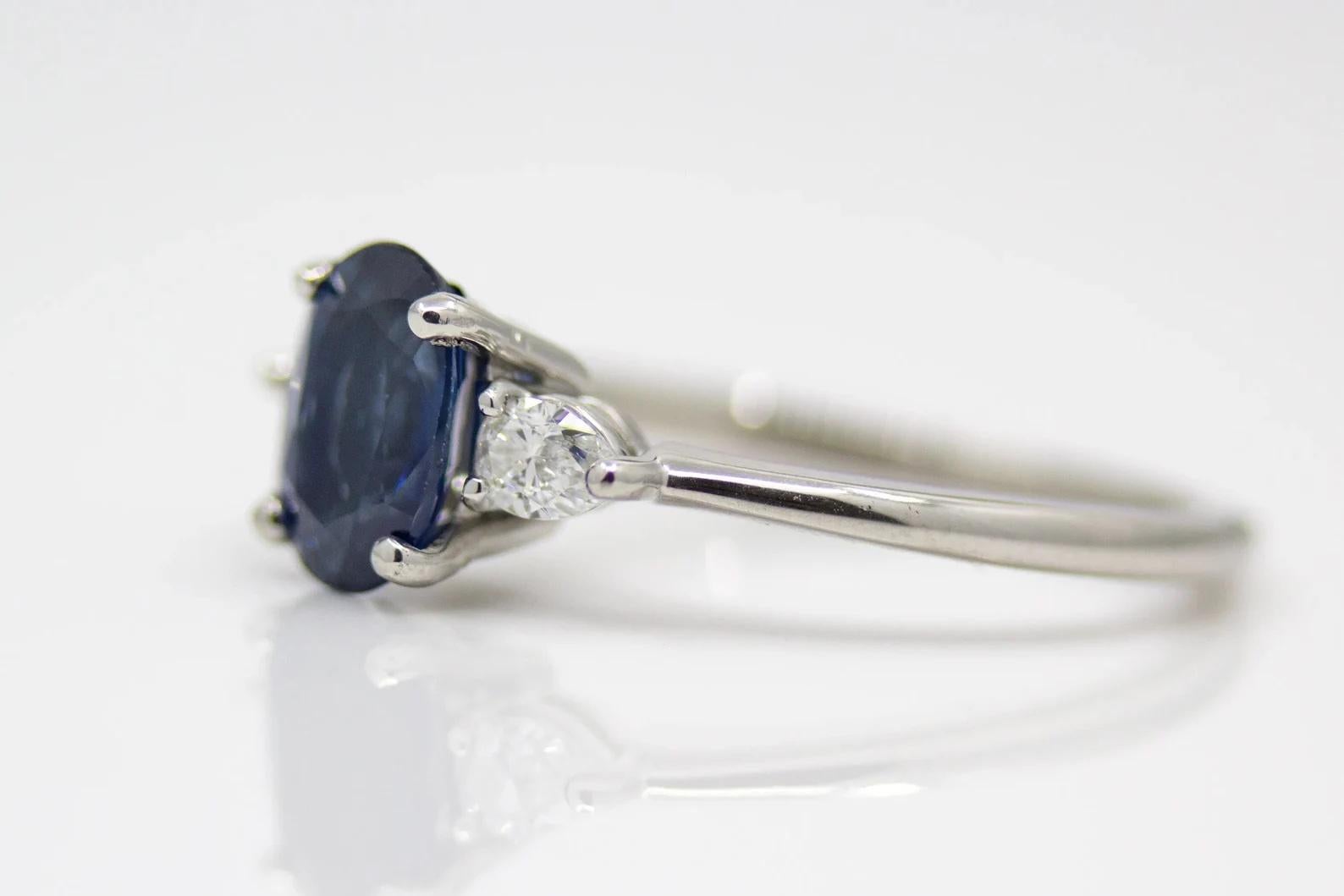 A timeless sapphire, and pear shaped diamond three stone ring set in platinum.

Centering this ring is a beautiful 1.59 carat natural vivid blue Ceylon sapphire. Grading as VS1 clarity and vivid blue color, the natural sapphire is a beautiful and