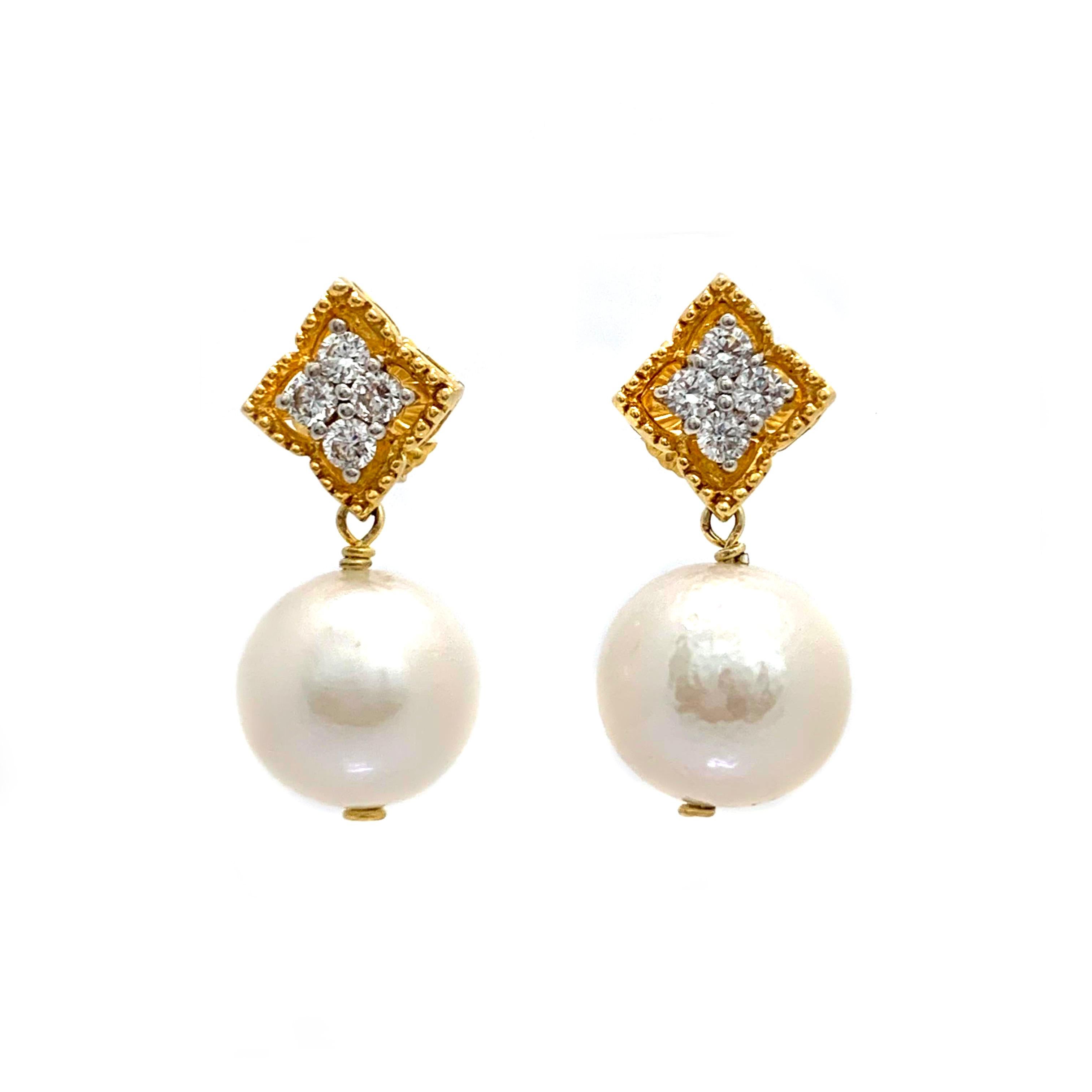 Elegant 15mm Cultured Pearl Drop Earrings

These elegant pair of earrings feature a pair of lustrous 15mm cultured Edison pearls and adorned with round simulated diamonds, handset in 18k yellow gold vermeil over sterling silver. The pearls measured