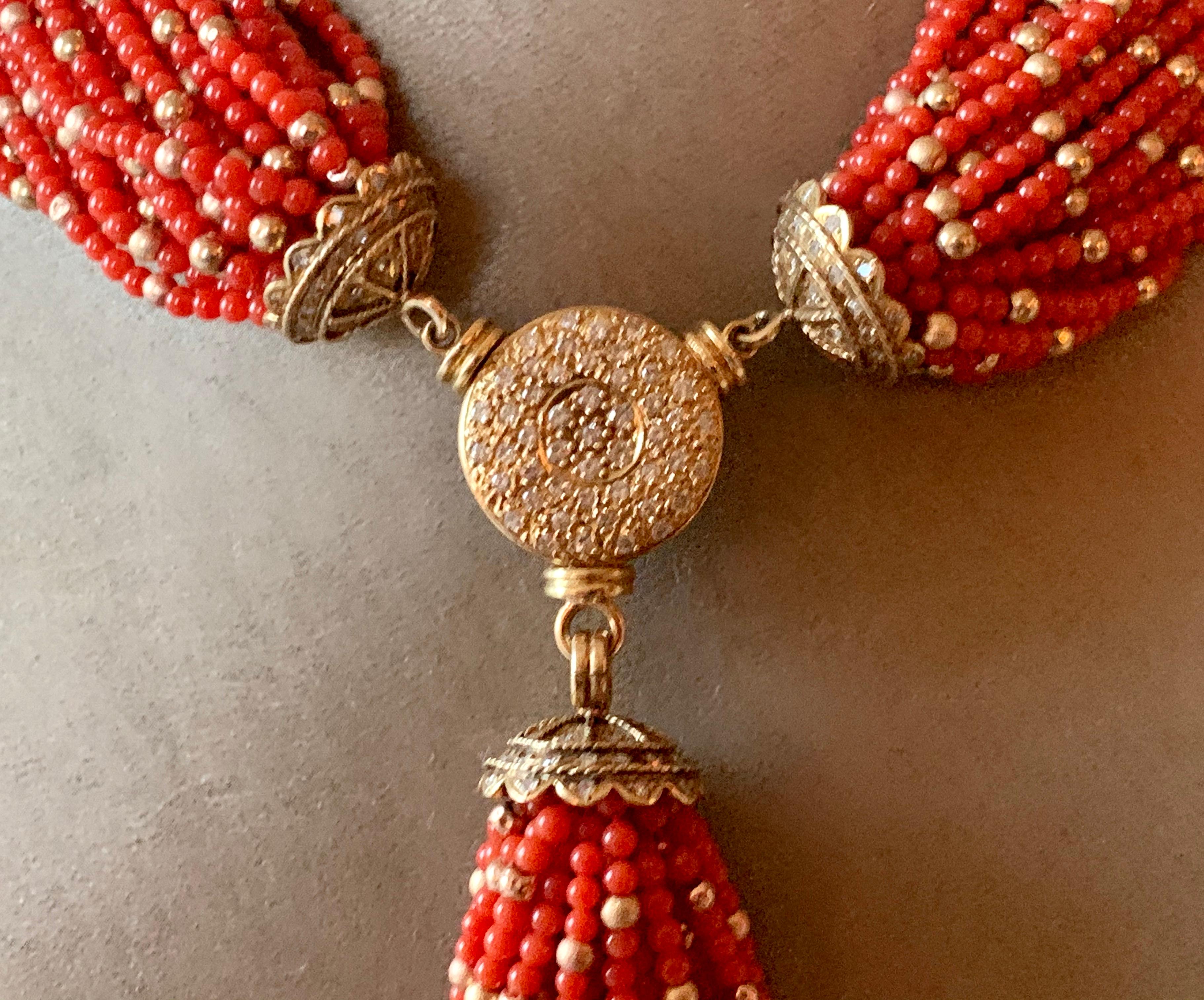 A rare torsade of 2.7 mm deep red coral and gold beads necklace witch a detachable tassel. 
This vibrant 31 strand natural coral torsade adds the perfect splash of color to any fashionable moment. Its versatile look trends from vintage-bohemian-chic