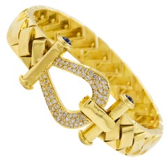 Elegant 18-Karat Gold Woven Strap Bracelet with 65 Diamonds and 4 Sapphires