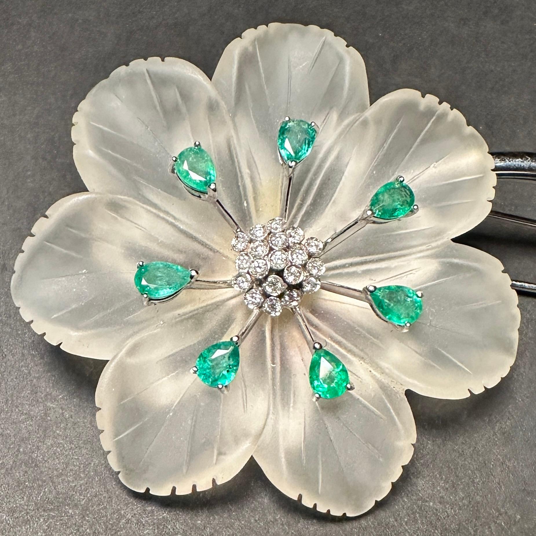Large 18k white gold, diamond and emerald floral form pin brooch with spinach Jade and rock crystal. Diamond and emerald centered above carved rock crystal petals and Jade leaves.
39 diamond with approx. total diamond weight .50cts 
7 pear shaped
