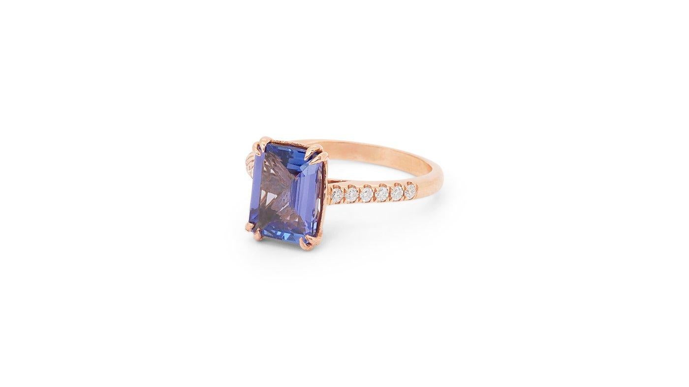 A gorgeous solitaire ring with a dazzling 2.11 carat emerald cut natural tanzanite. It has 0.12 carat of side diamonds which add more to its elegance. The jewelry is made of 18K Rose Gold with a high quality polish. It comes with IGI certificate and