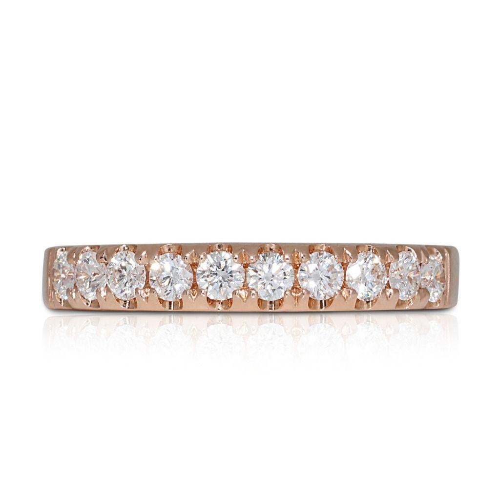 Each diamond within the ring is meticulously selected for its exceptional clarity and brilliance, creating a breathtaking display of sparkle and fire. These diamonds are flawlessly set within a lustrous 18K yellow gold setting, adding a touch of