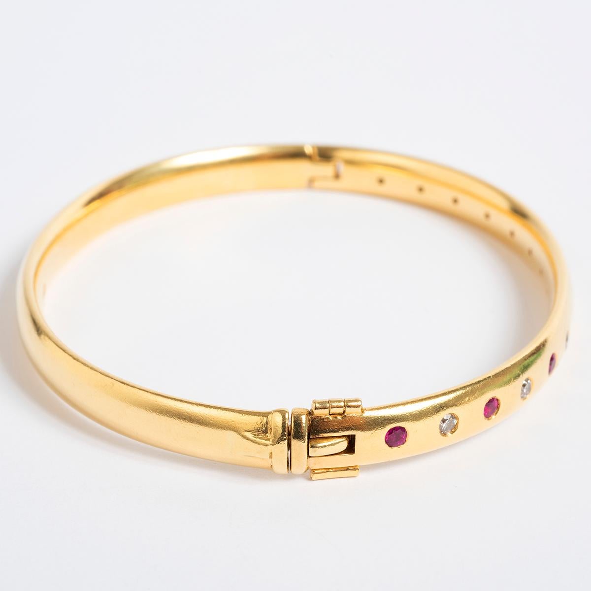A unique piece within our carefully curated Vintage & Prestige fine jewellery collection, we are delighted to present the following: This classic 18K Yellow Gold bracelet measures 50mm with with rubies and diamonds. A perfect present for her ..