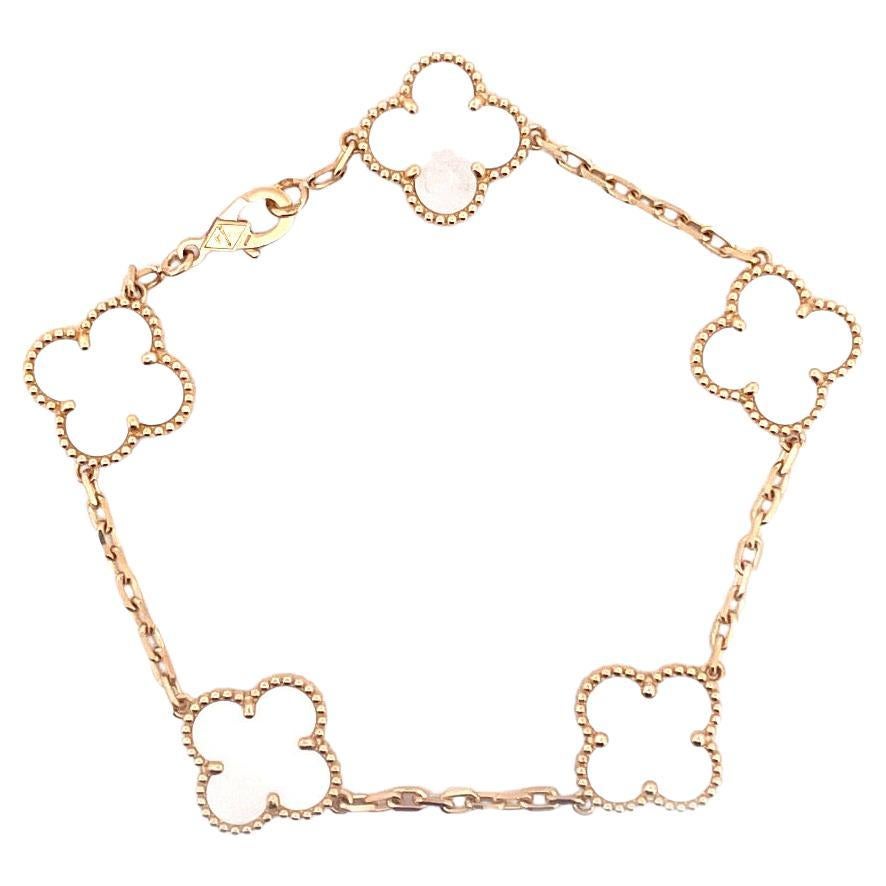 Indulge in the timeless beauty of our 18k yellow gold VCA MOP 5 motifs bracelet. Crafted with exquisite precision, this stunning piece features five captivating mother-of-pearl motifs. The bracelet weighs a delicate 11.2 grams, ensuring both comfort