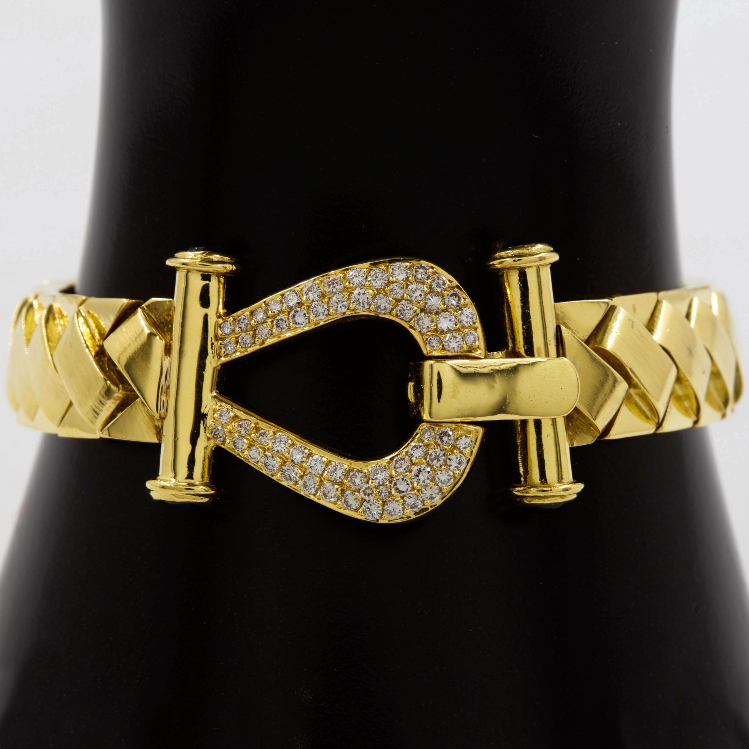 WOVEN YELLOW GOLD BRACELET WITH DIAMOND-AND-SAPPHIRE HORSESHOE CLASP
Circa late 20th century
Item # 012MGP03W

A truly exquisite evening bracelet, this elegant design is a complex display of woven links with a brushed finish on the upper links and a