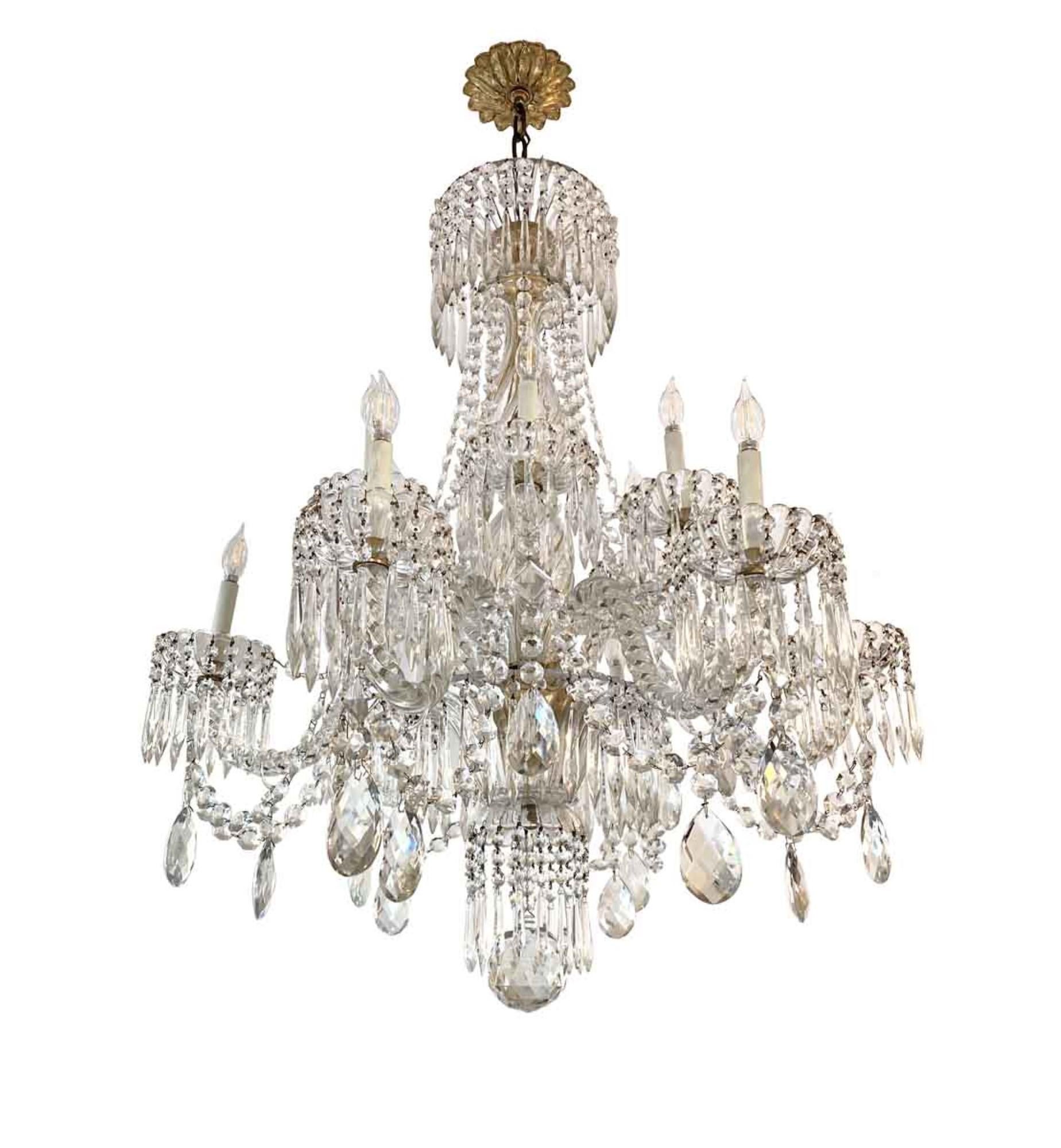 12-light Baccarat clear crystal chandelier, circa 1920. The body, arms, and bobeche are genuine Baccarat crystal. The hanging crystals are not and must have been replaced. This elegant chandelier is excellent quality. This can be seen at our 333