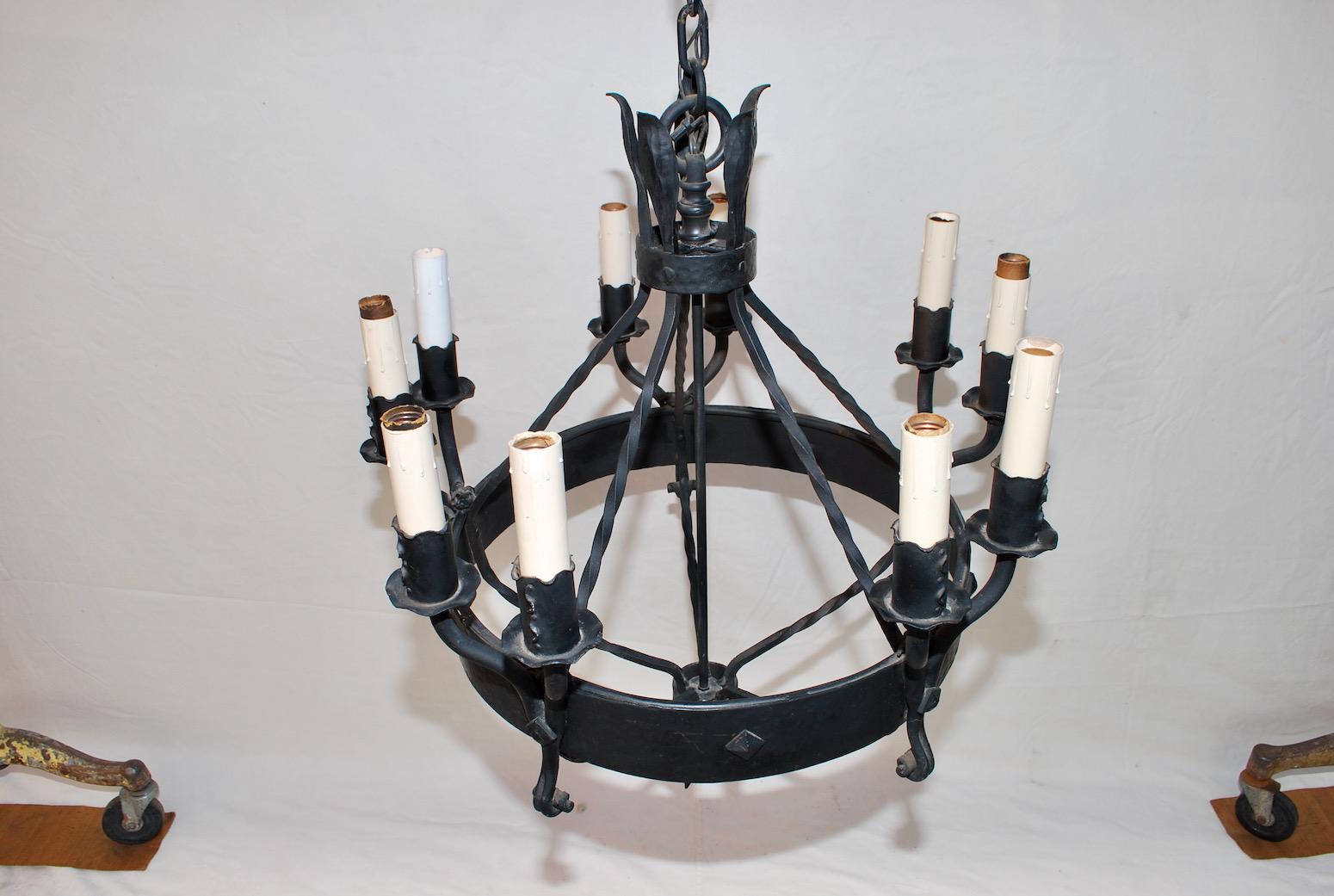 A beautiful and elegant 1920's wrought iron chandelier, at some times in the past, this chandelier was repainted.