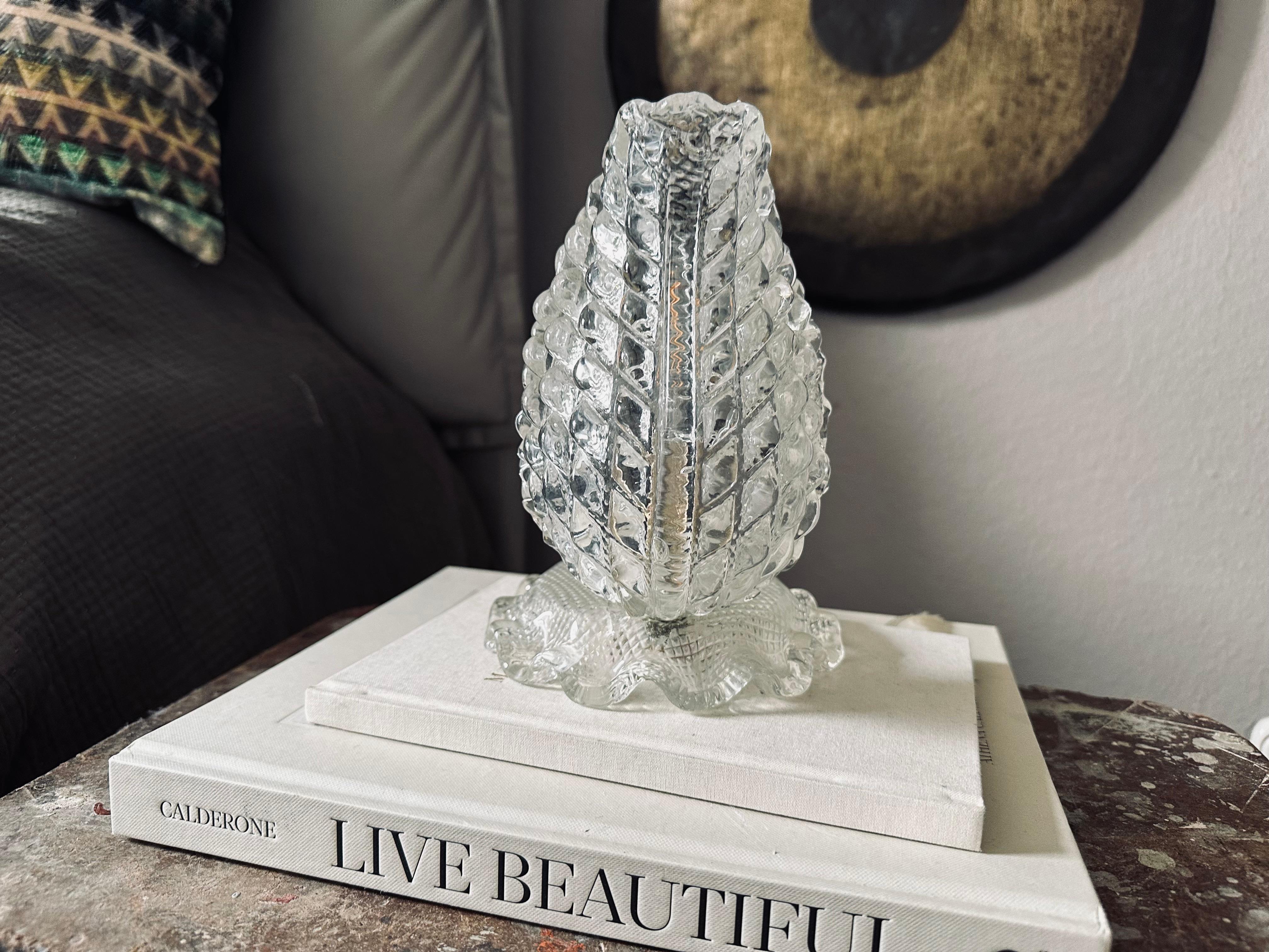 This striking table lamp from the 1920s is a beautiful example of Art Deco elegance and Italian craftsmanship. The thick, clear Murano glass is shaped like a stylized acanthus leaf and is softly illuminated from behind, creating a subtle yet