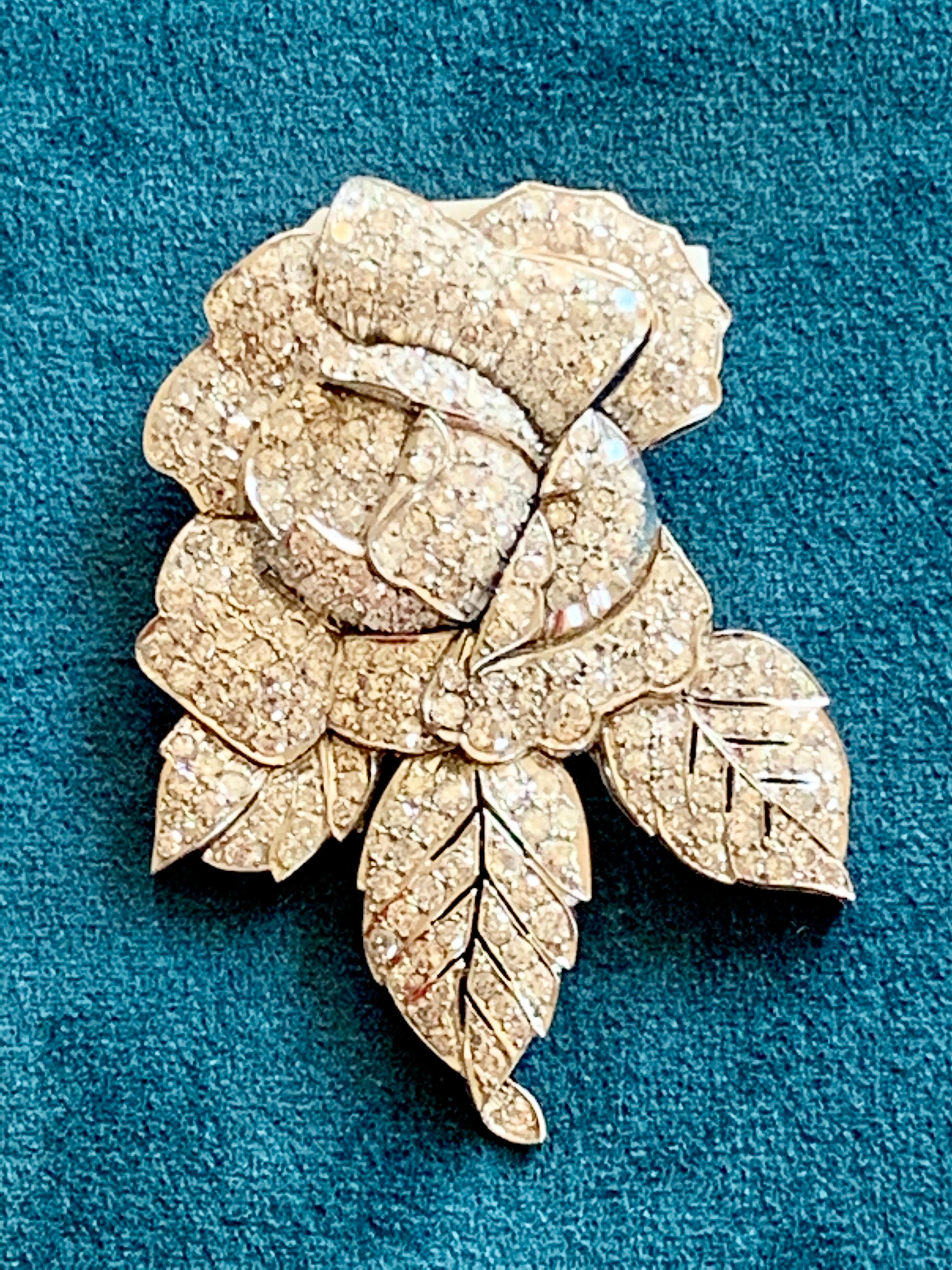 Platinum and Diamond Flower Clip- Brooch The stylized flower brooch is pavé-set with 286 brilliant cut diamonds weighing approximately 10.00 ct.  Measuring 6.5cm x 4.6 cm. 
