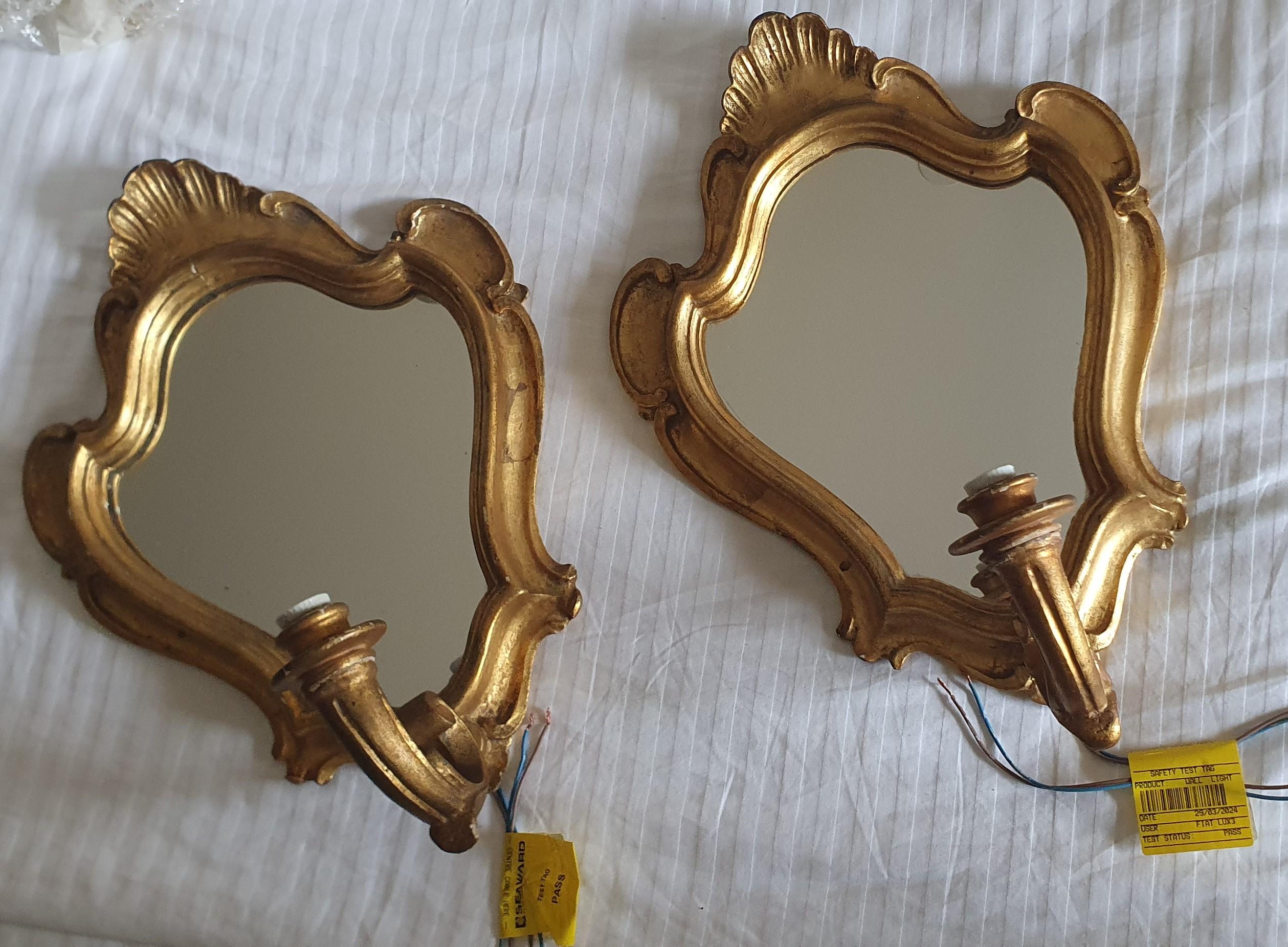 Nous présentons à la vente une superbe paire d'appliques murales Girandole italiennes des années 1940 de style baroque, sculptées à la main et ornées de miroirs dorés à l'huile. 

Ces magnifiques appliques sculptées ont un cadre de 3 cm de