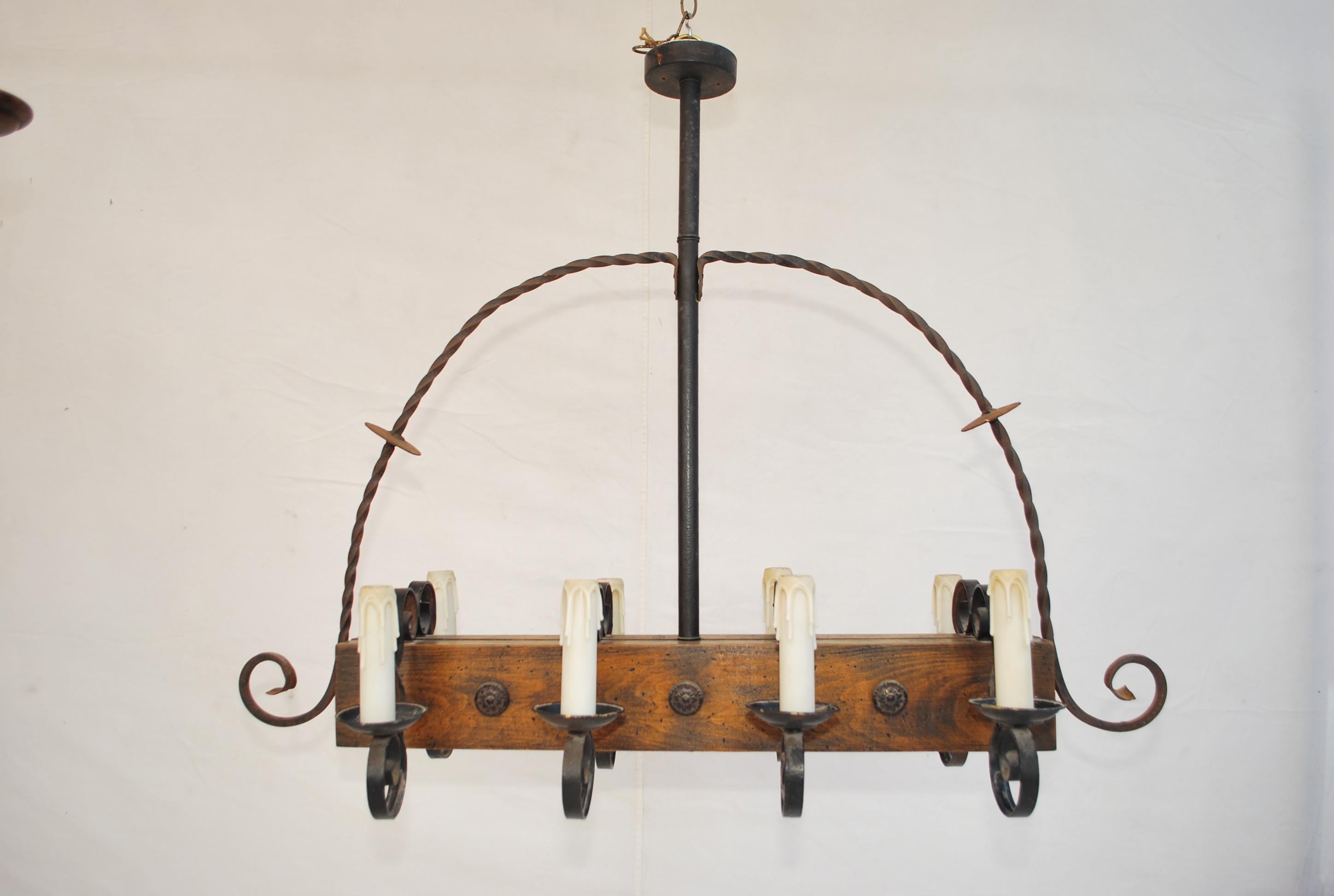 A beautiful wood and iron chandelier, the patina is allot nicer in person, the iron was hand-forged.