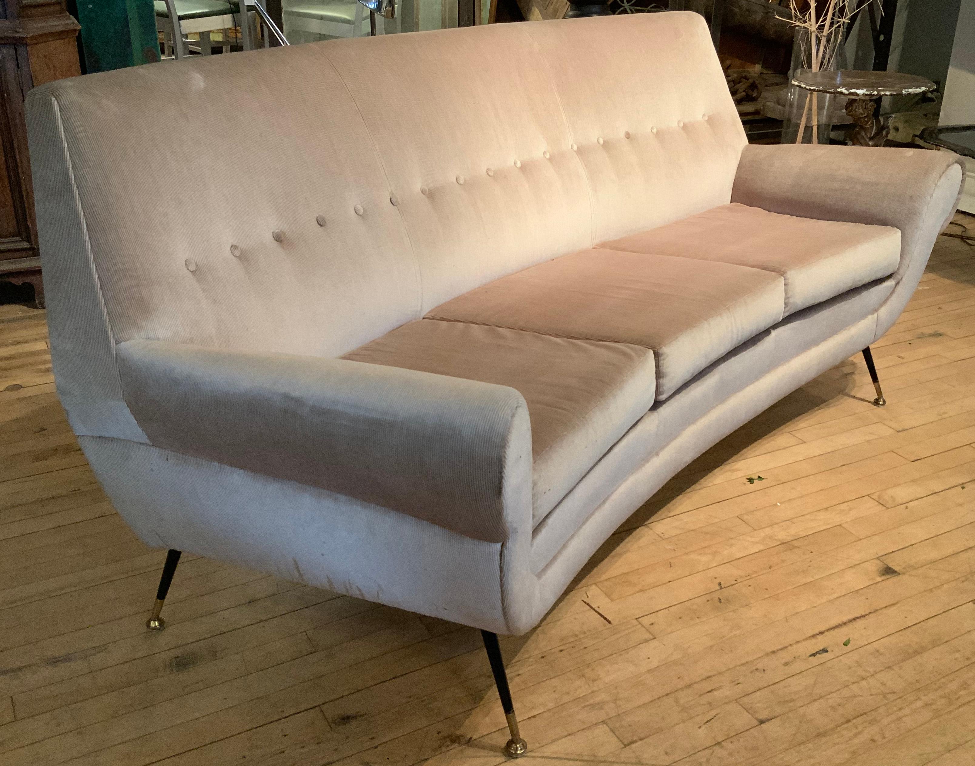 a very elegant and beautiful 1950's Italian sofa, with a slightly curved frame -- wonderful design and scale - perfect for a variety of settings. raised on tapered legs with brass caps and feet. in recent beige velvet/corduroy upholstery, which has