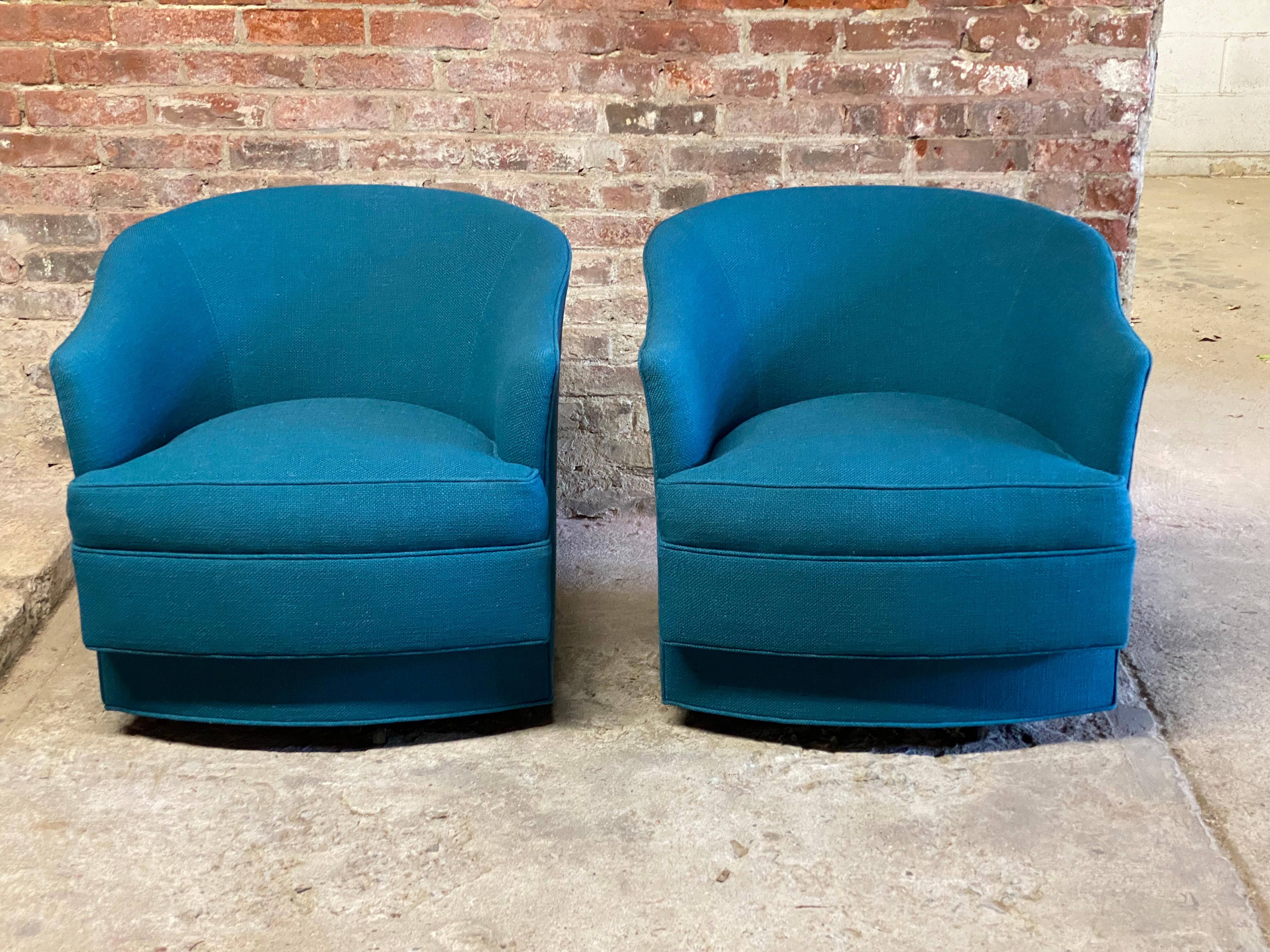 Pair of elegant John Stuart swivel chairs. The John Stuart label on any piece of furniture is a distinct sign of luxury, detail to design and quality in 20th century furniture manufacturing. Reupholstered in a heavy duty teal fabric. Good overall
