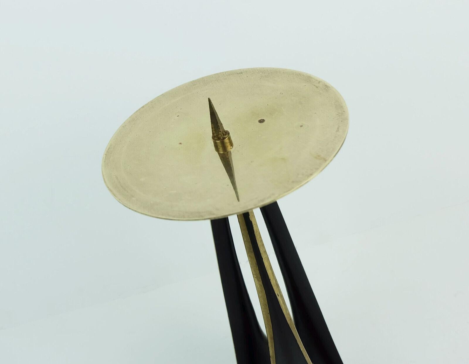 Mid century modern candle holder designed by German goldsmith and industrial designer Klaus Ullrich in the 1950s and manufactured by Faber & Schumacher Duisburg. 
Made of brass, partially lacquered in matte black. Streamline design, a perfect