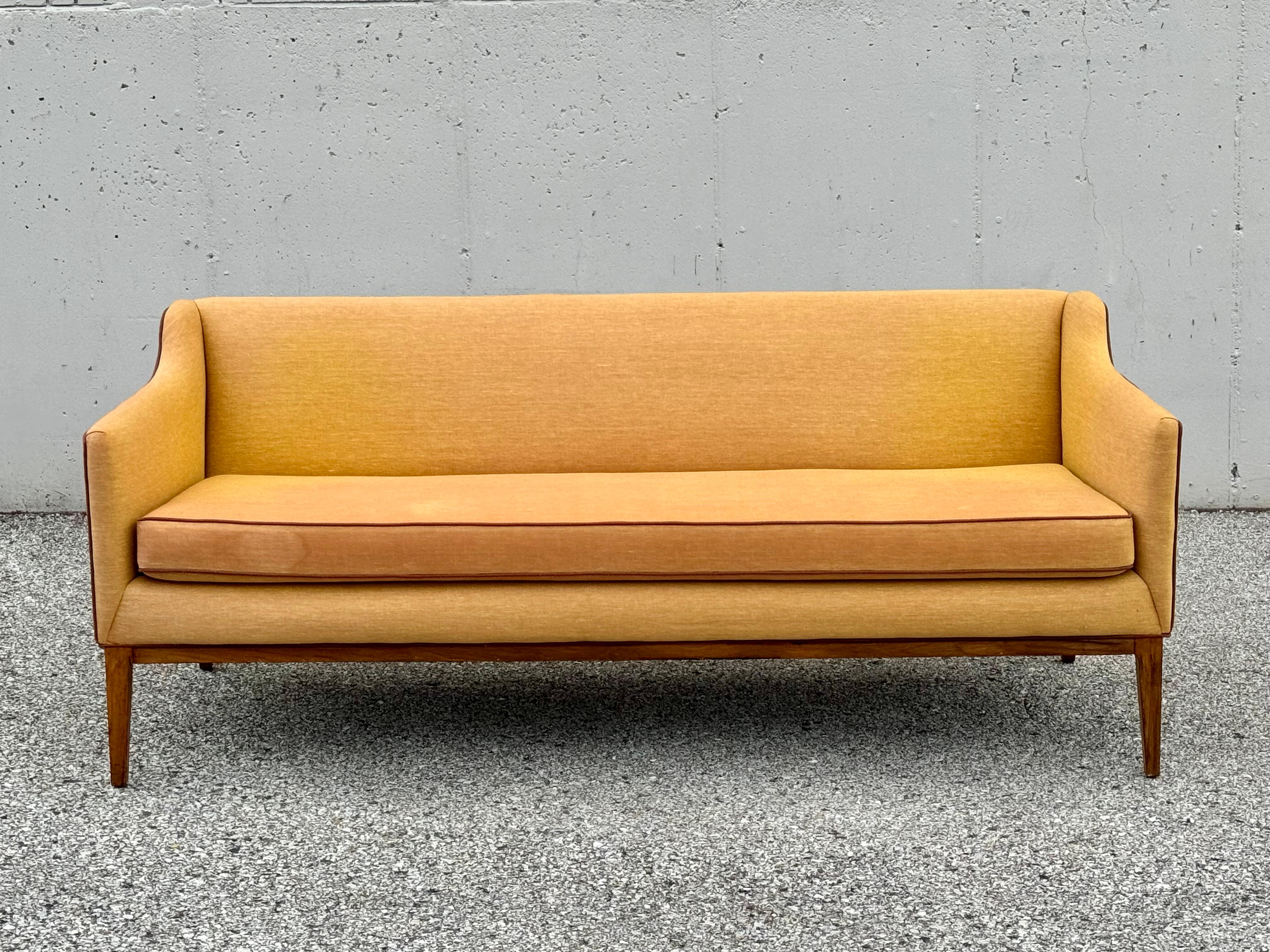 Fabulous MCM Jens Risom attributed designed sofa or settee with wood frame on tapered legs. The sofa arm, drops down from the back creating a sculptural effect. The front of the sofa is 72