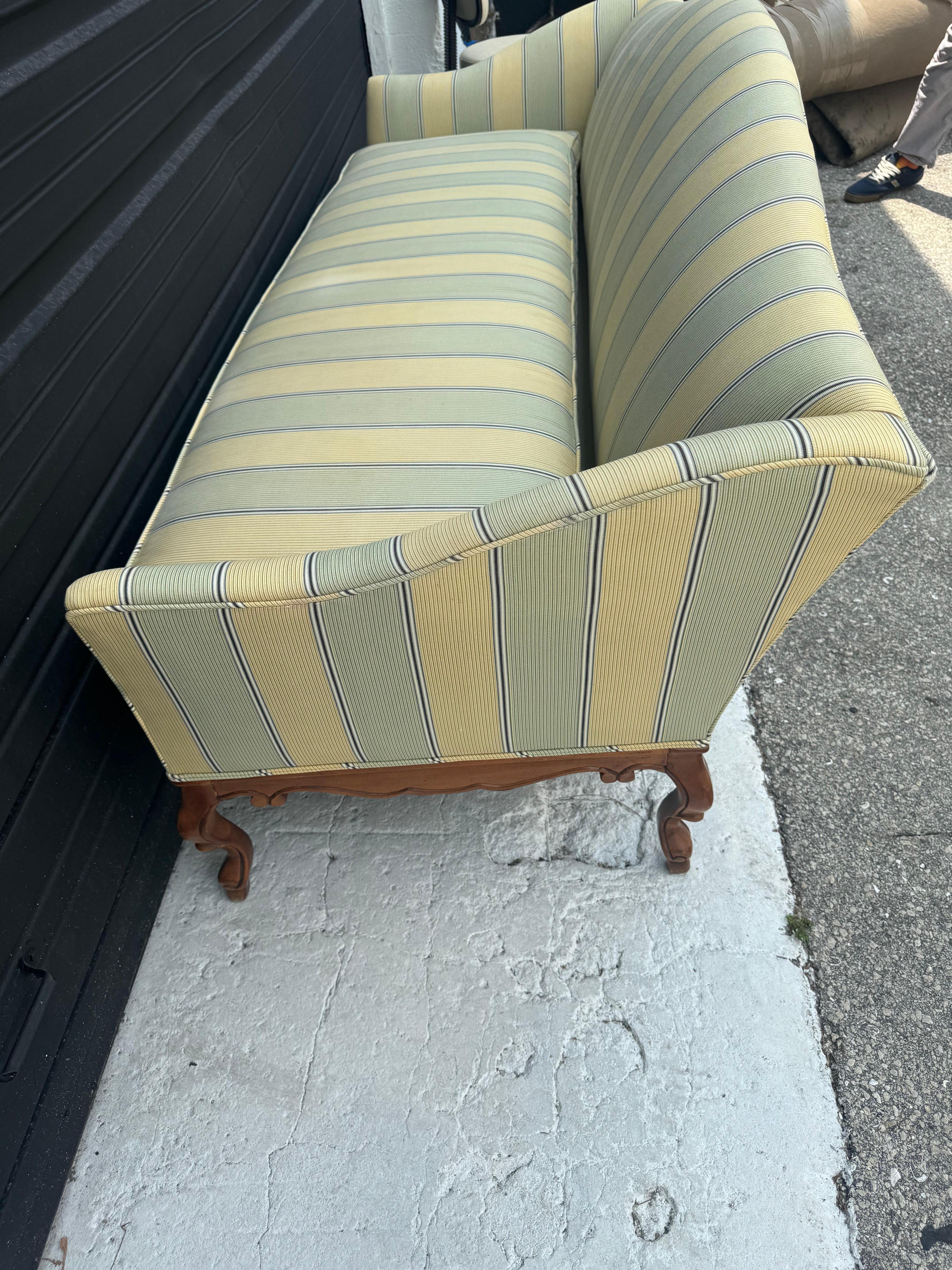 This beautiful sofa comes to us from a lovely estate in Palm Beach. Its elegant lines are enhanced by the stripped fabric.  It has been upholstered recently. 