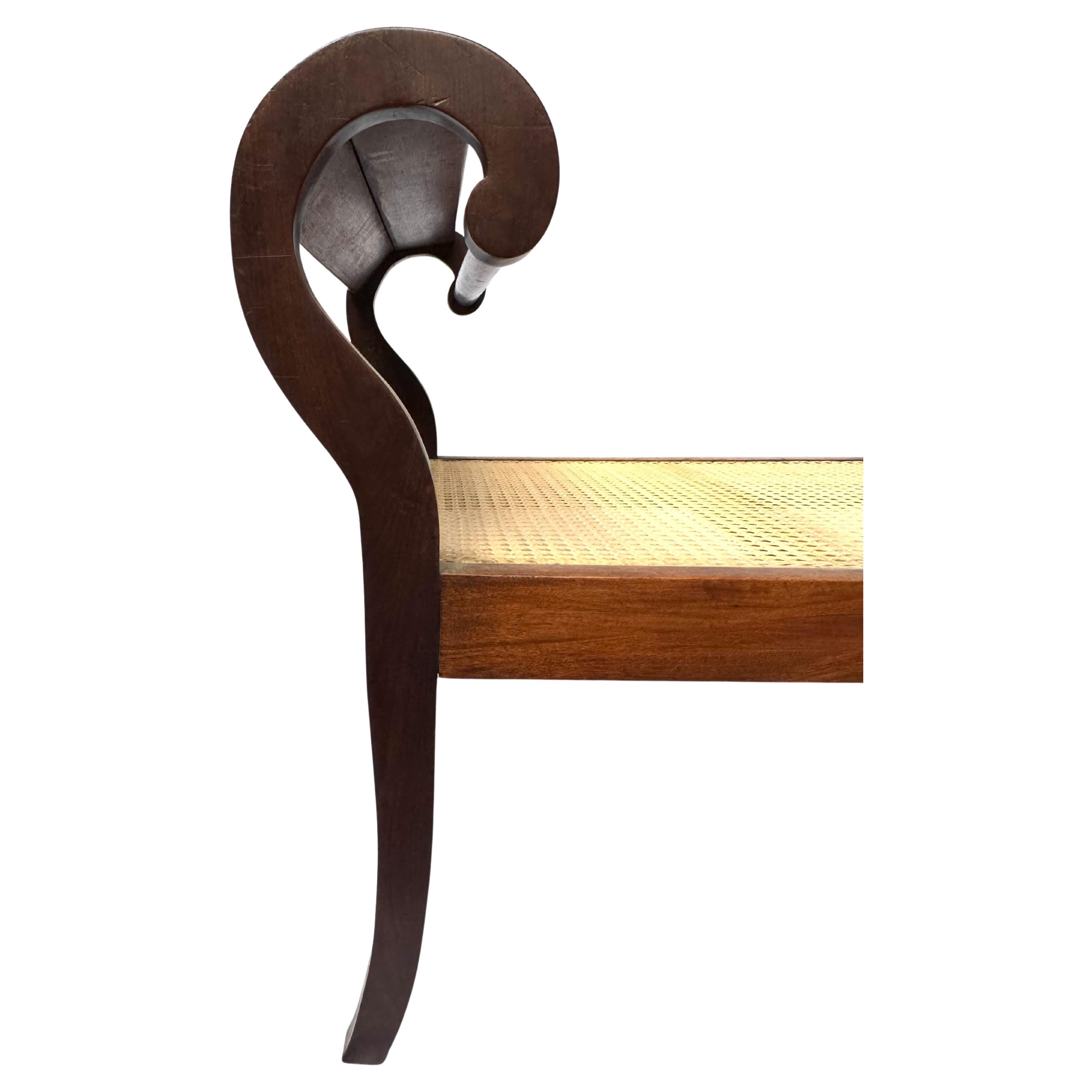 Elegant 19th-Century Brazilian Empire Bench with Cane Seat and Rare Provenance
A refined and architectural 19th-century Brazilian bench, exquisitely crafted in solid tropical hardwood and gracefully evoking the late Empire and Regency stylistic