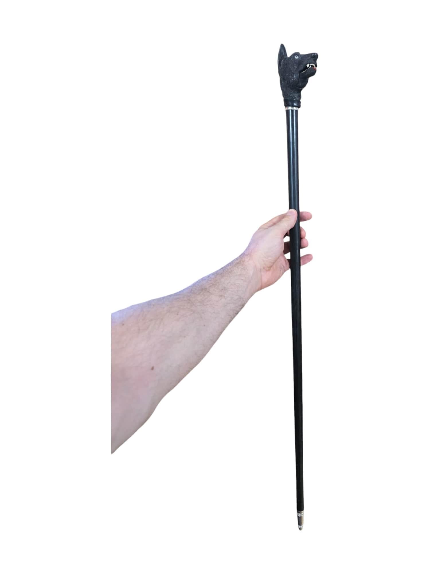 Elevate your collection with this elegant 19th-century ebony cane. Expertly carved from rich ebony wood, this cane features a distinctive handle depicting a dog with an open mouth, showcasing the remarkable craftsmanship of the