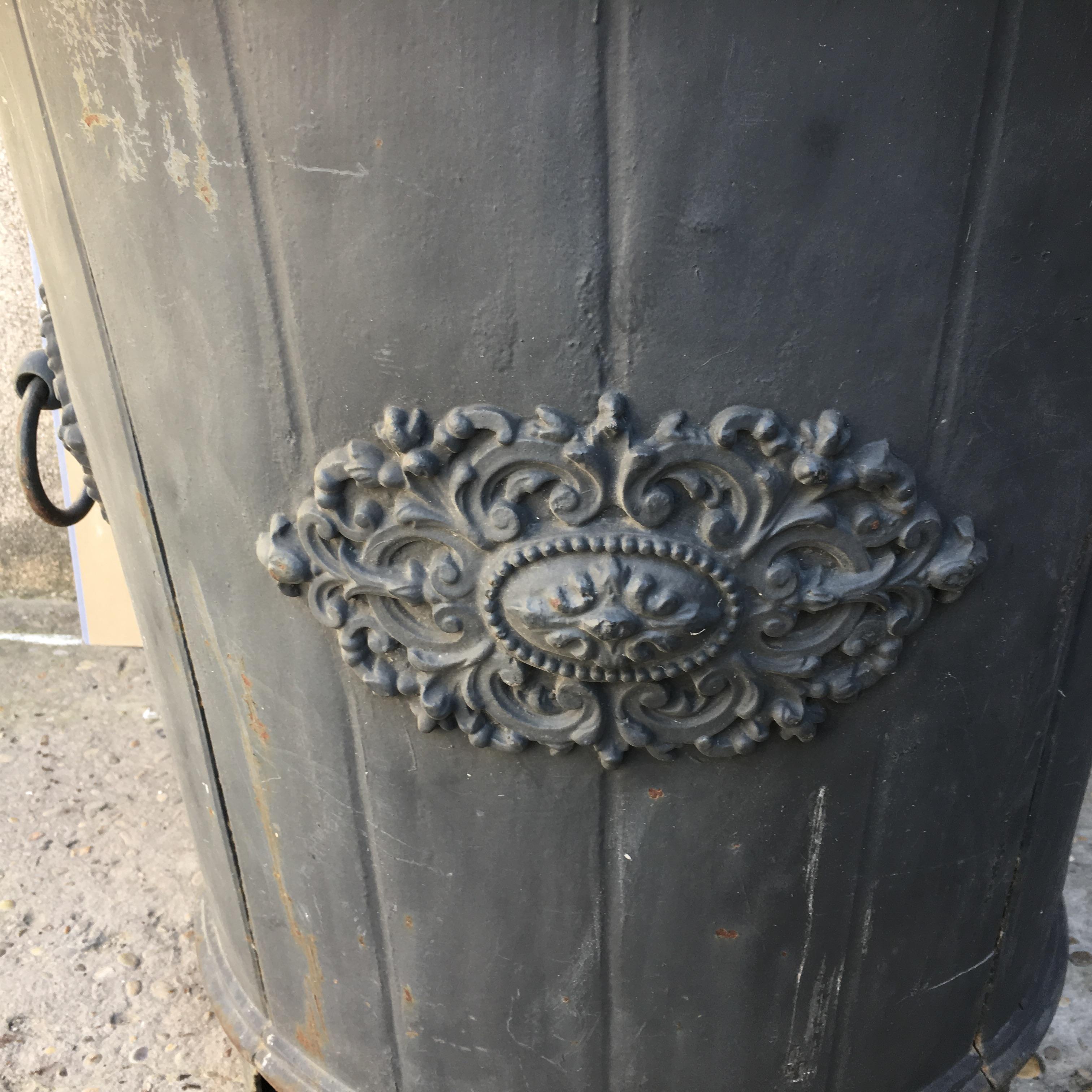 An elegant French cast iron garden planter or urn with a stunning blue green patina. Beautiful slate blue color. Decorative designs on all 4 sides with two handles. Strong supporting feet below the base.

This beautiful planter originates from a