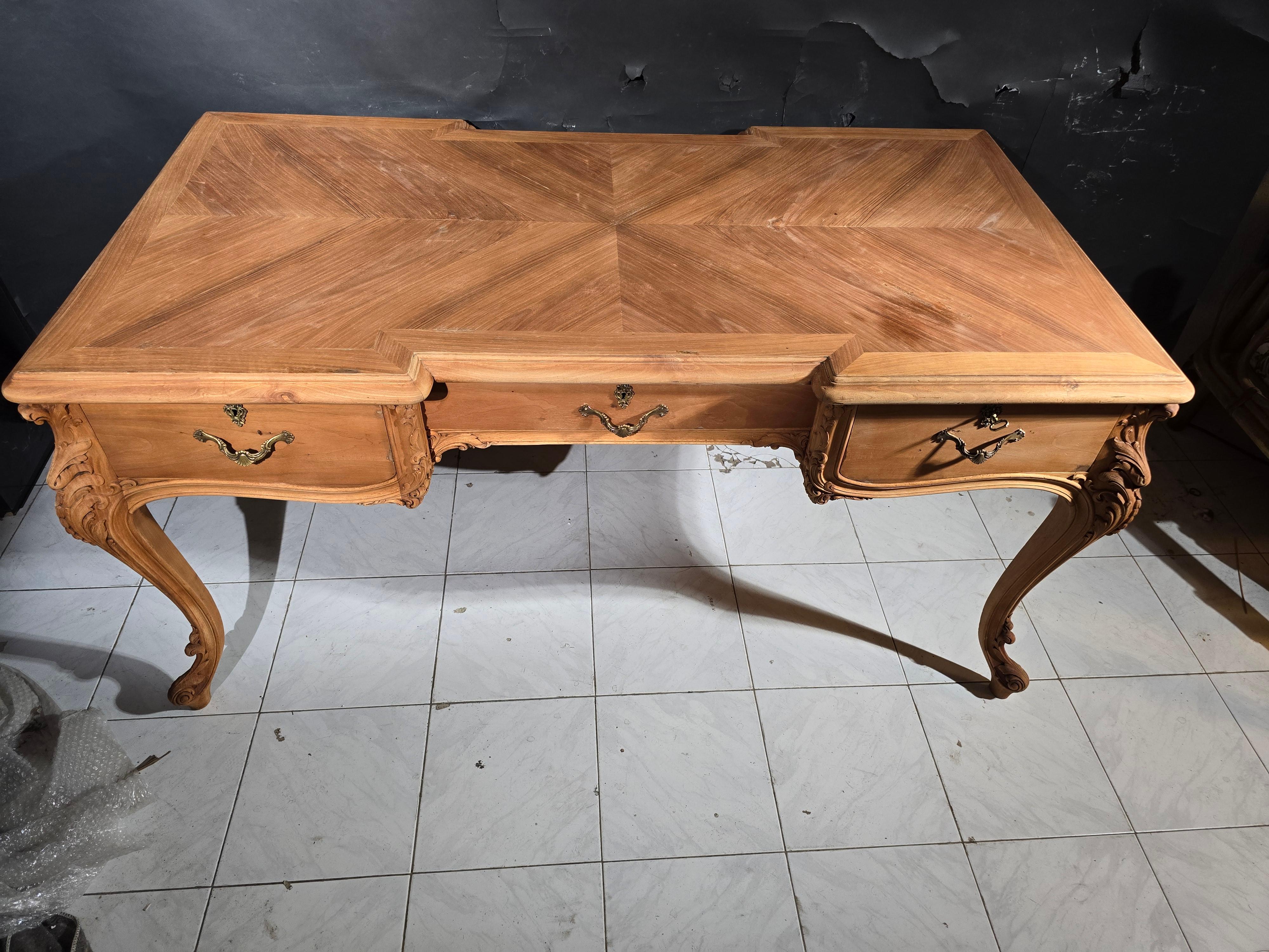 This exquisite 19th-century French desk is a stunning example of fine craftsmanship and timeless design. Constructed from solid fruitwood, this elegant piece features intricate bronze adornments and beautifully carved legs, making it a perfect