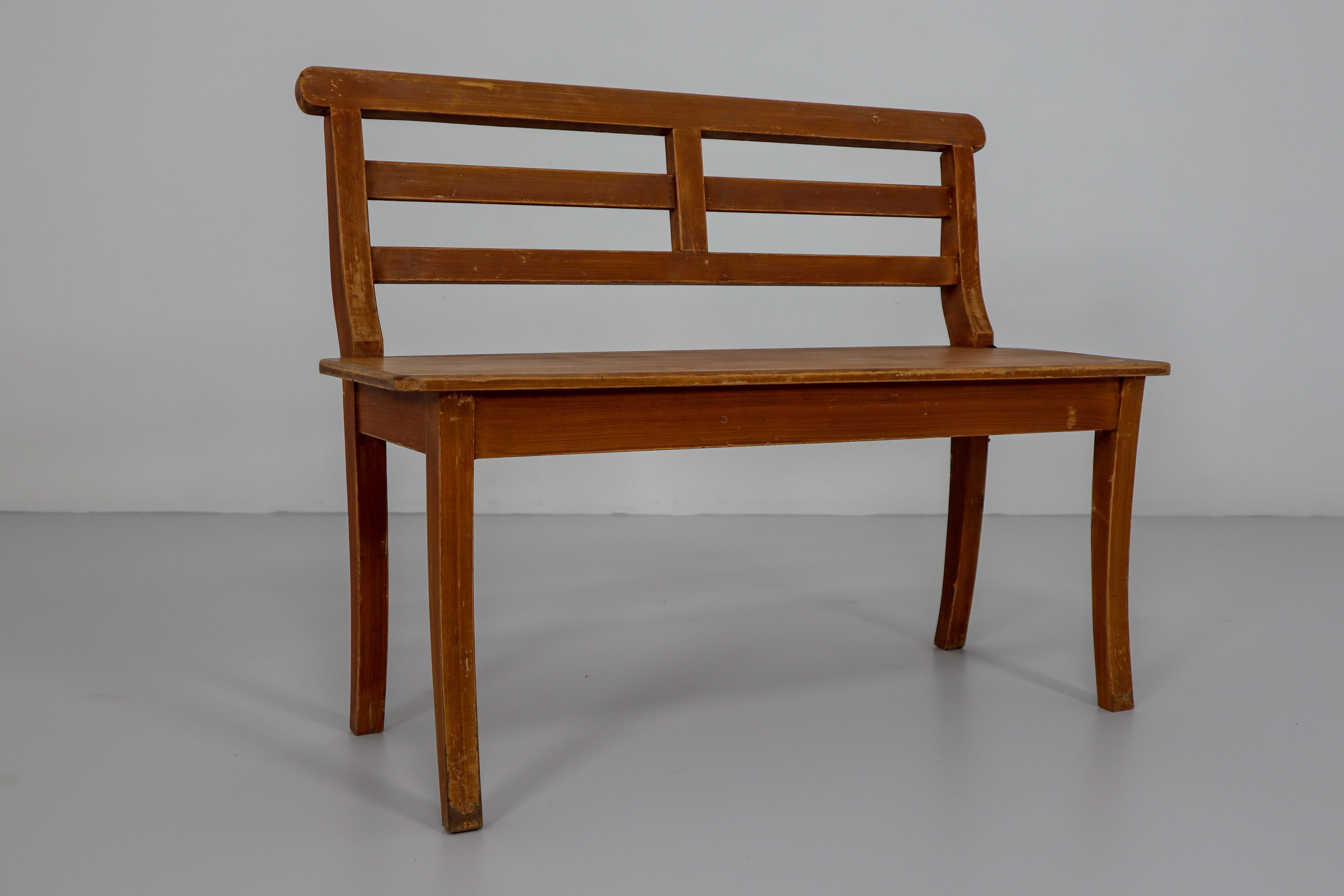 A very unusual and with a superb patina, 19th century, German Antique hall bench in pine.