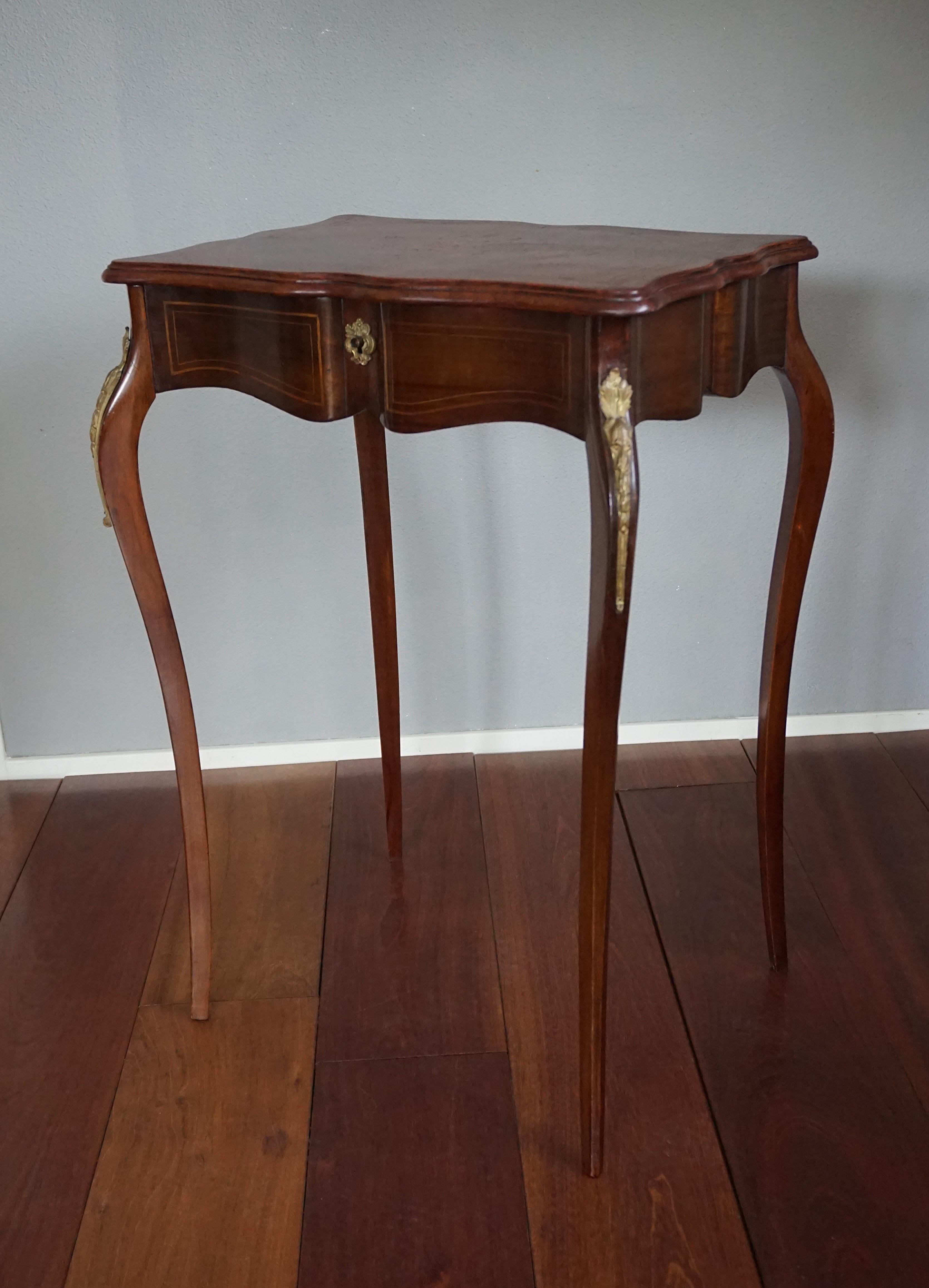 Very elegant, handcrafted table with lid and beveled mirror.

If you have an eye for elegant designs then this French, antique nutwood table is a visual treat every time you will look at it. Handcrafted in the late 1800s this antique table displays