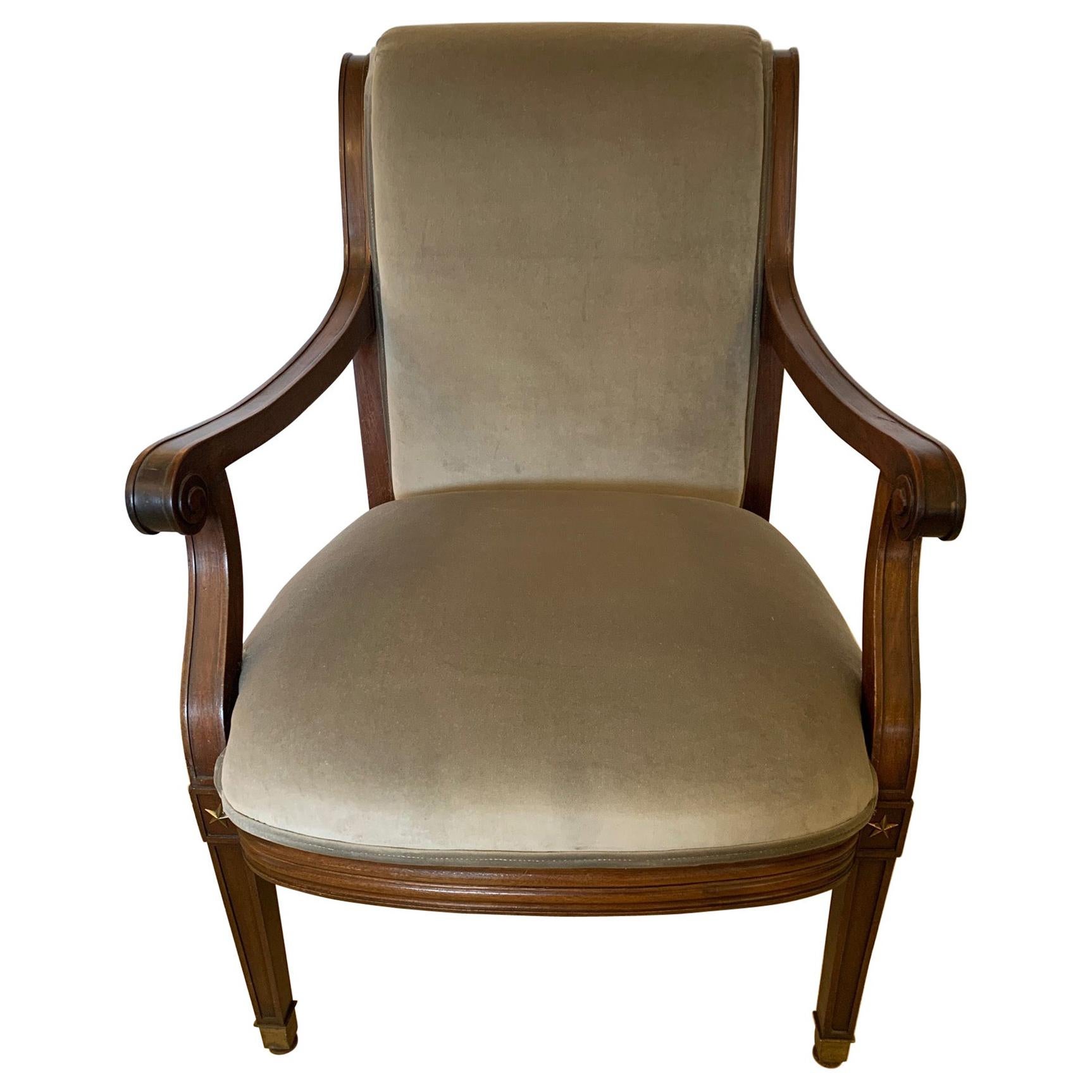 Regal Regency 19th century neoclassical mahogany and newly upholstered grey velvet arm chair having handsome brass stars where legs meet the seat and scroll arms. Brass caps finish the legs.
Measures: arm height 26.25
seat depth 21.5.