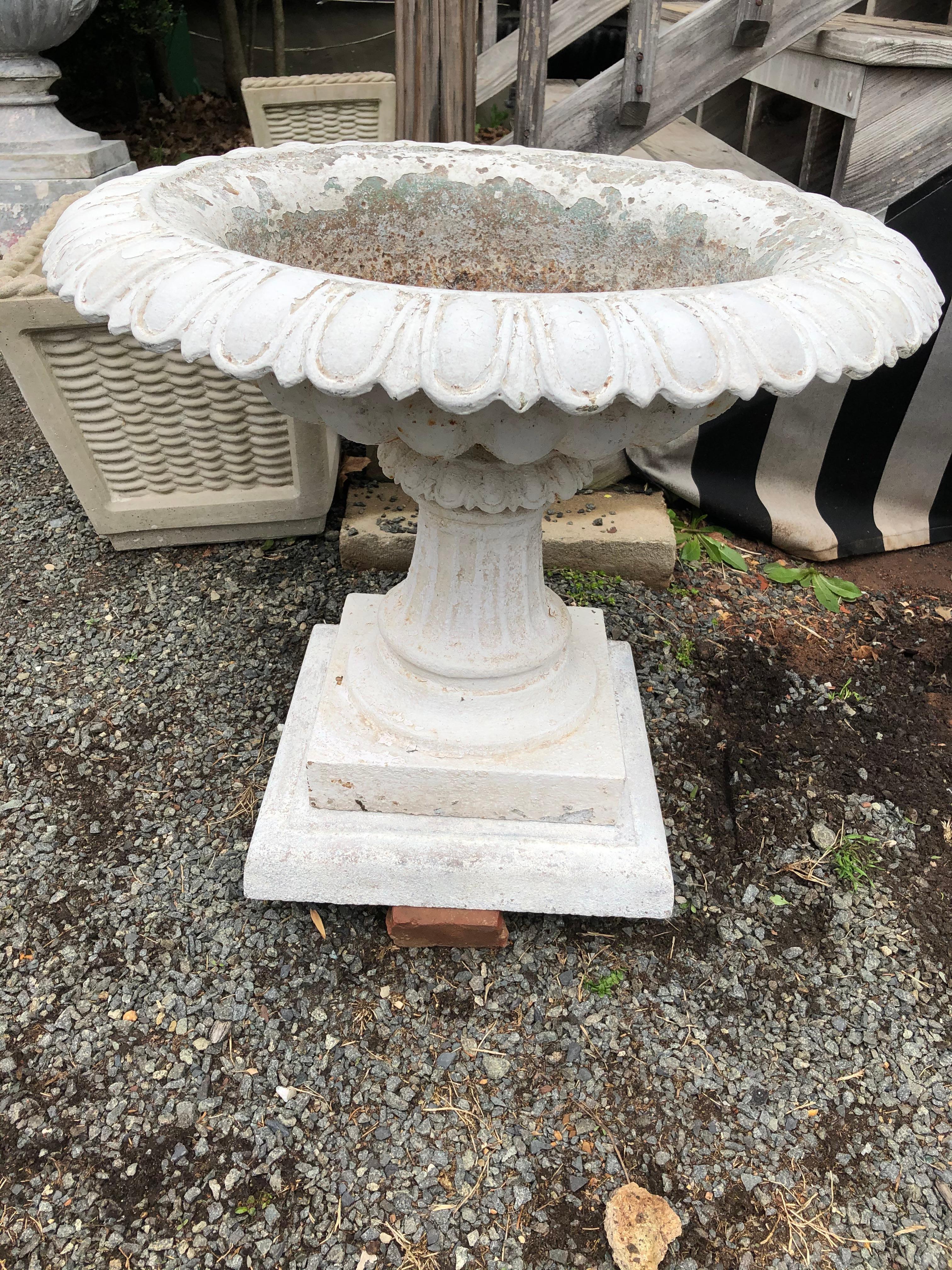 A beautiful white cast iron tazza style garden urn with hole drilled in center, so would make a lovely fountain. Sits on a plinth 14