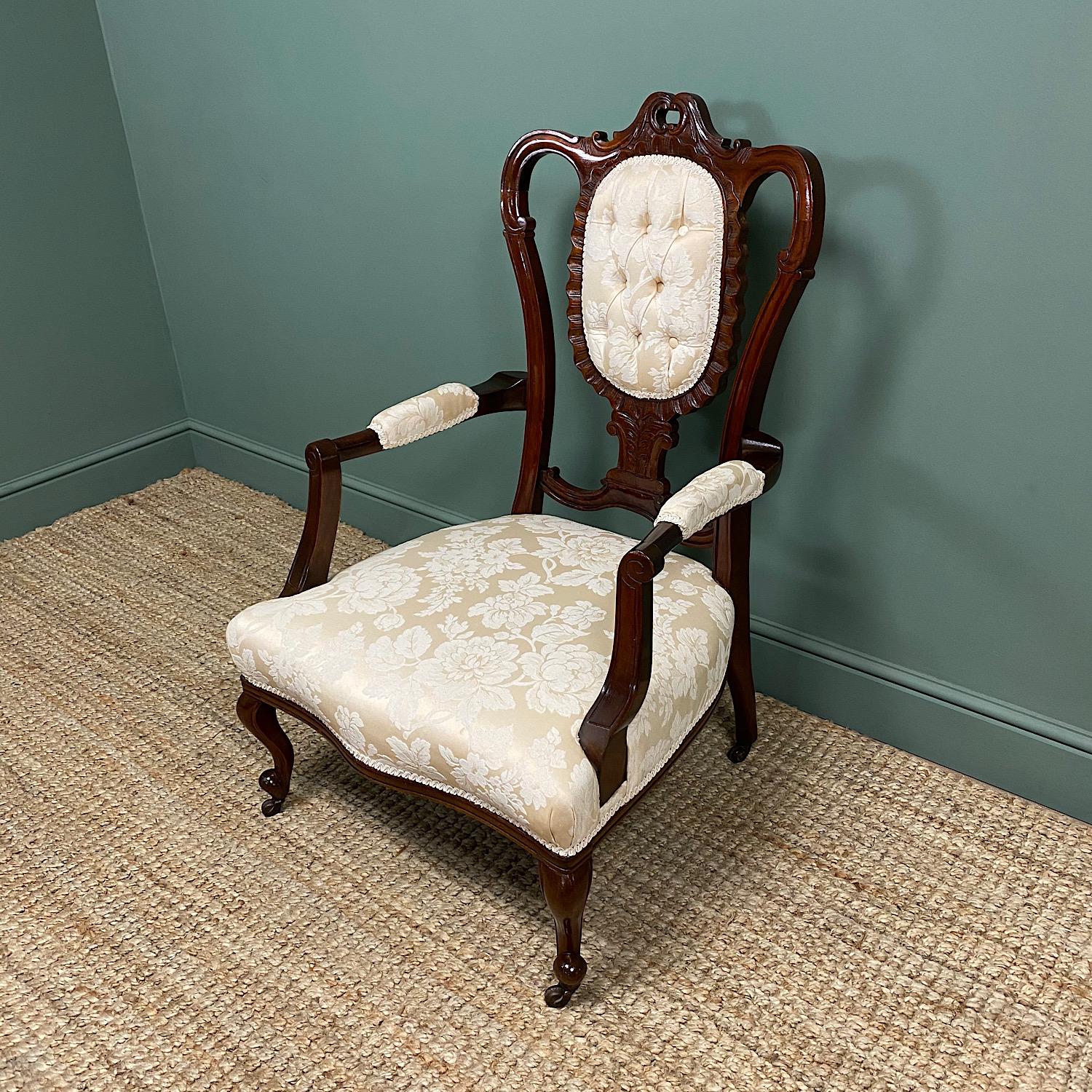 Elegant Victorian Upholstered Antique Arm Chair

This Elegant late 19th century Mahogany Victorian Upholstered Antique Arm Chair dates from ca. 1890 and has a beautifully carved back with two out swept arms, splayed back legs and cabriole front legs