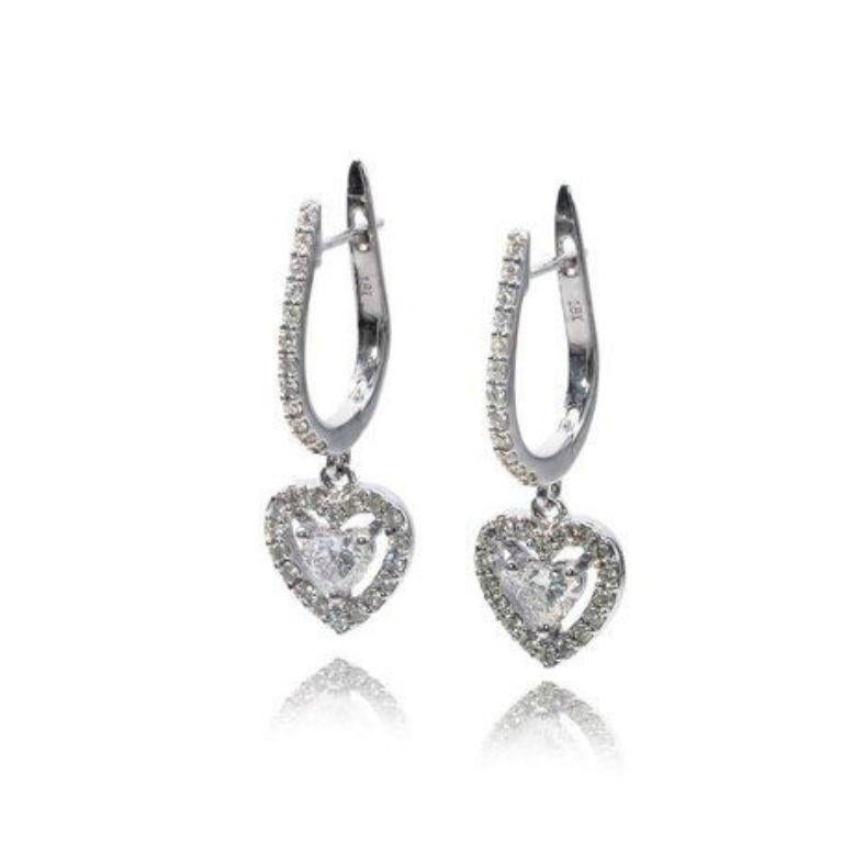 Embrace captivating elegance with these breathtaking earrings, featuring a mesmerizing 2.02-carat heart brilliant diamond duo complemented by shimmering pear-shaped side stones, all set in gleaming 18K white gold. This exquisite pair, certified by