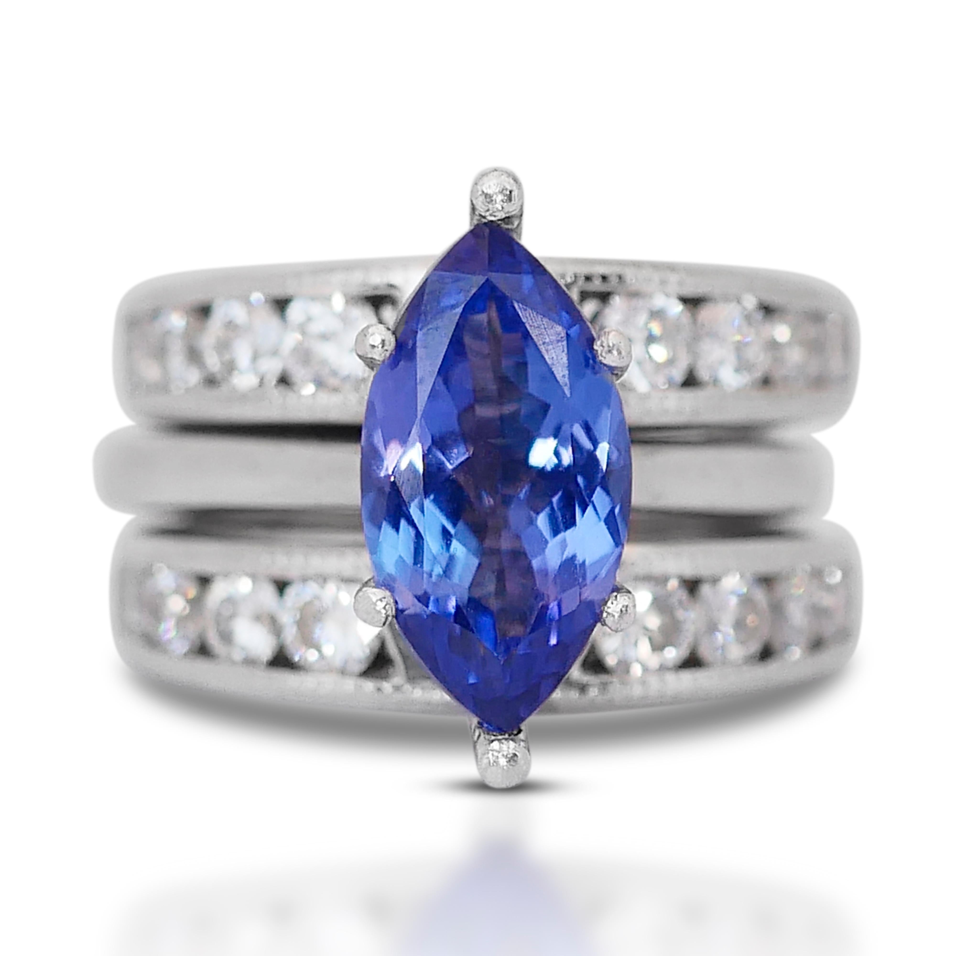 This exquisite ring exudes elegance and sophistication, featuring a captivating Tanzanite as its focal point and surrounded by a shimmering halo of diamonds.

At its center rests a magnificent Tanzanite, boasting a substantial 2.75 carat marquise