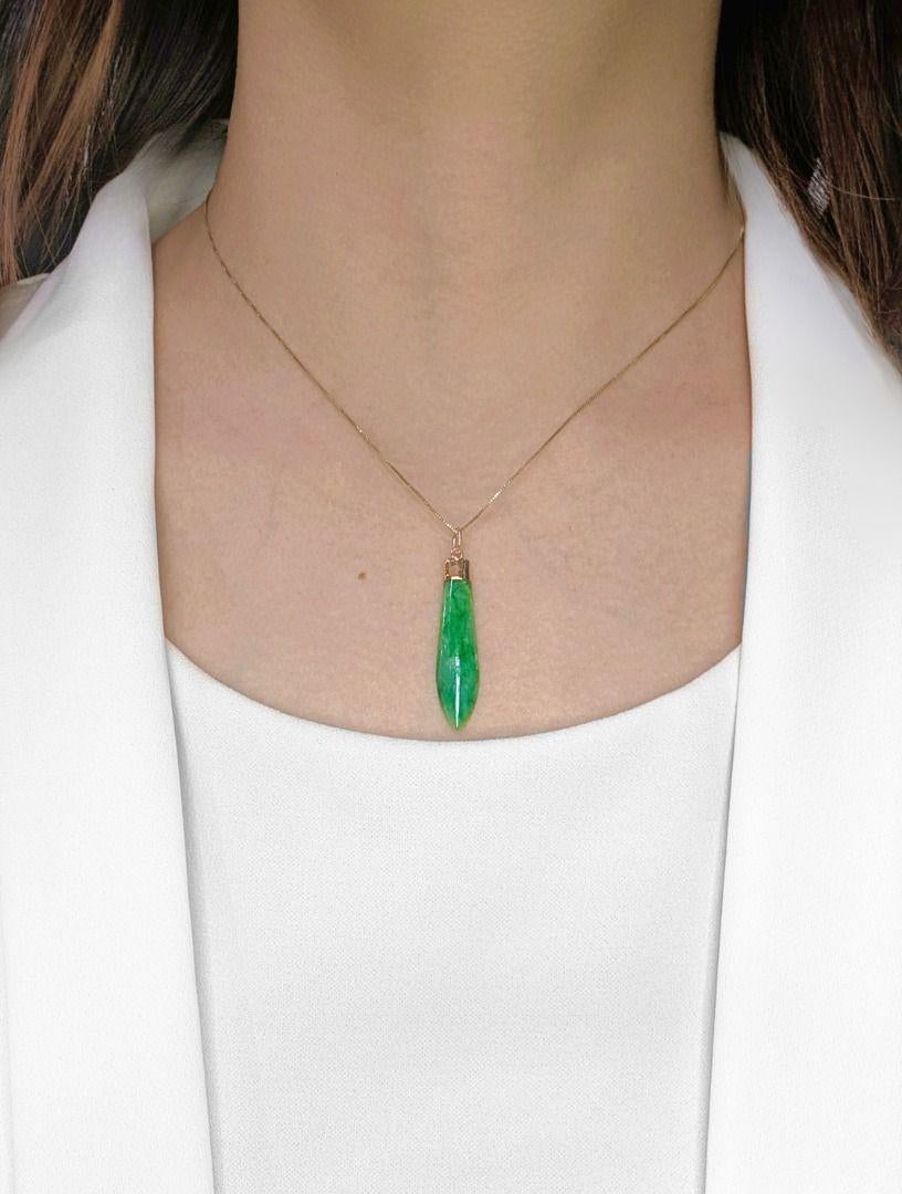 A captivating fusion of tradition and luxury, this 20K yellow gold pendant showcases a single jade gemstone, weighing 2 grams, in a rich green hue. Known for its timeless significance and symbolic meaning, the jade is gracefully set within a sleek