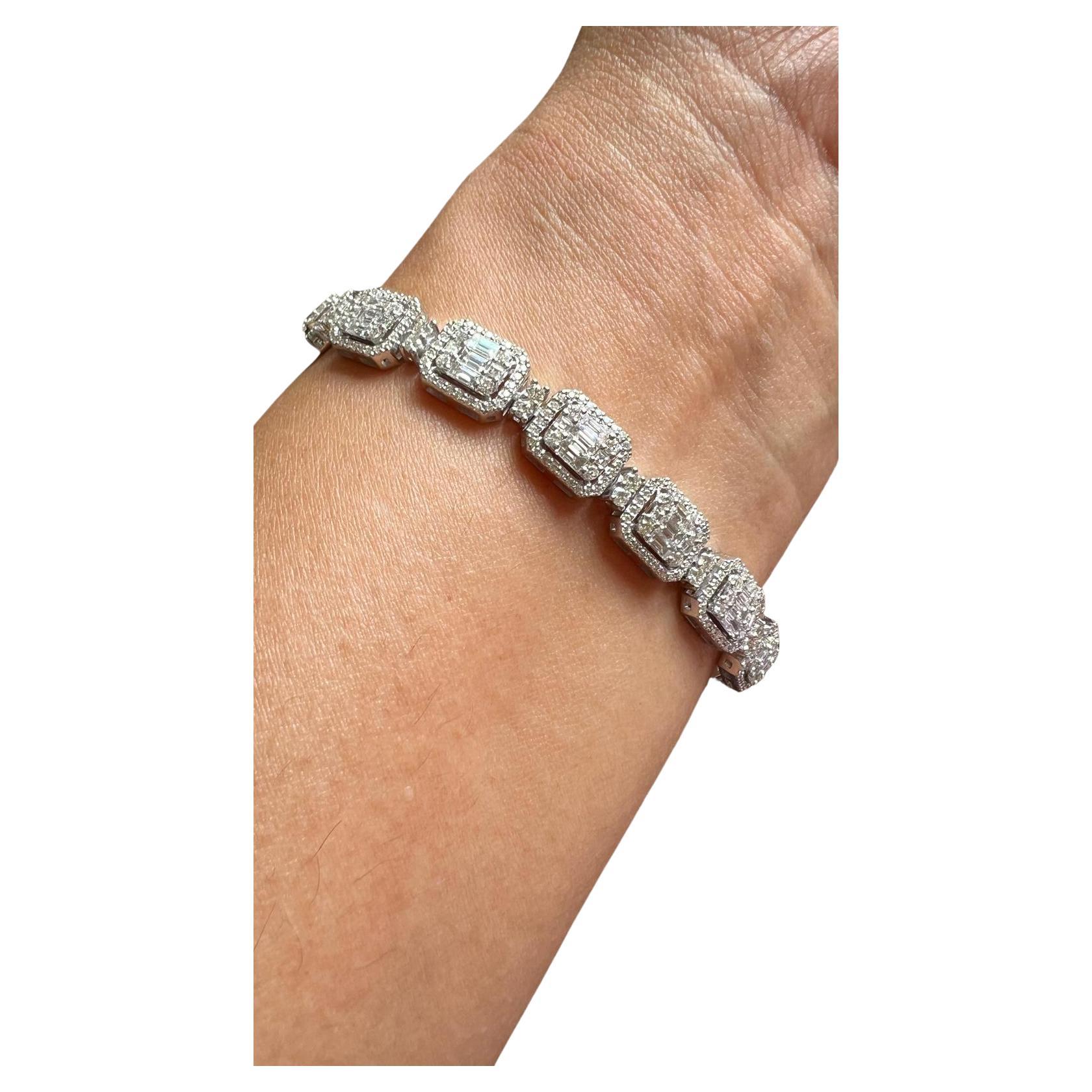 Indulge in timeless elegance with this breathtaking 5.70-carat diamond bracelet, crafted in luxurious 18K white gold. Featuring an exquisite design of meticulously set emerald-cut look using Baguatte diamonds and round brilliant diamonds, this piece