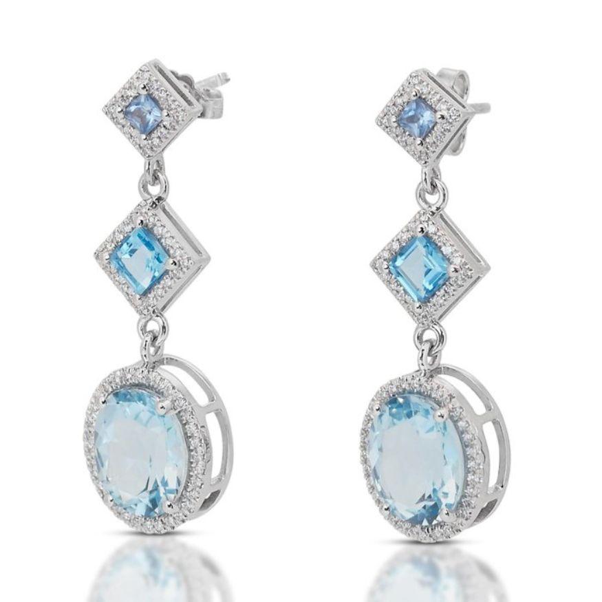 Cette bague exquise est ornée de deux majestueuses topazes ovales de taille mixte, d'un poids impressionnant de 7,02 carats. Les pierres de topaze présentent une teinte bleue captivante qui évoque les profondeurs sereines de l'océan, ajoutant une