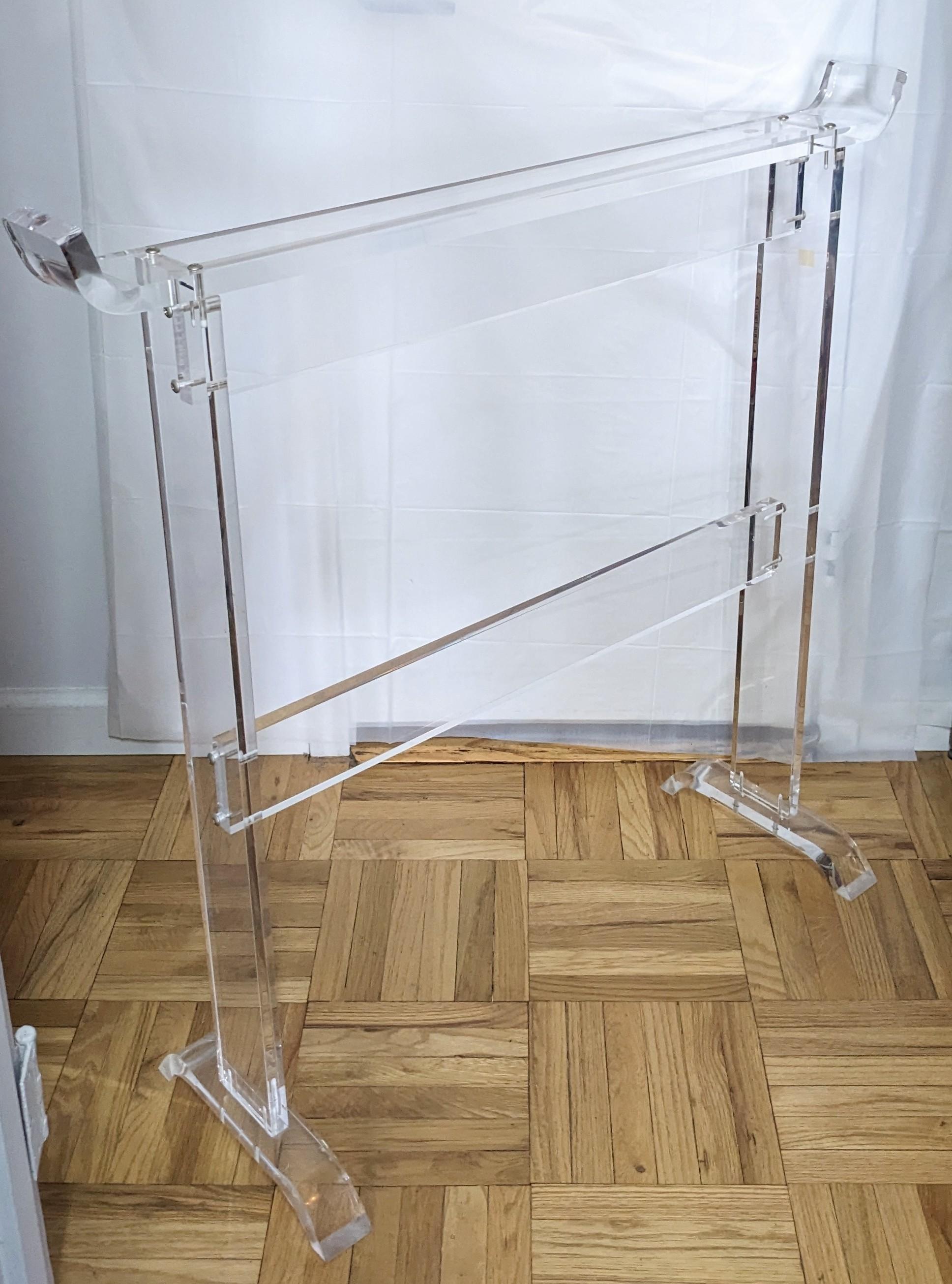 Elegant acrylic garment valet/ rack from the 1970's. Heavy, quality acrylic used for a practical and attractive bedroom accessory. Quality construction. 1970s USA. 
Top rail, 37
