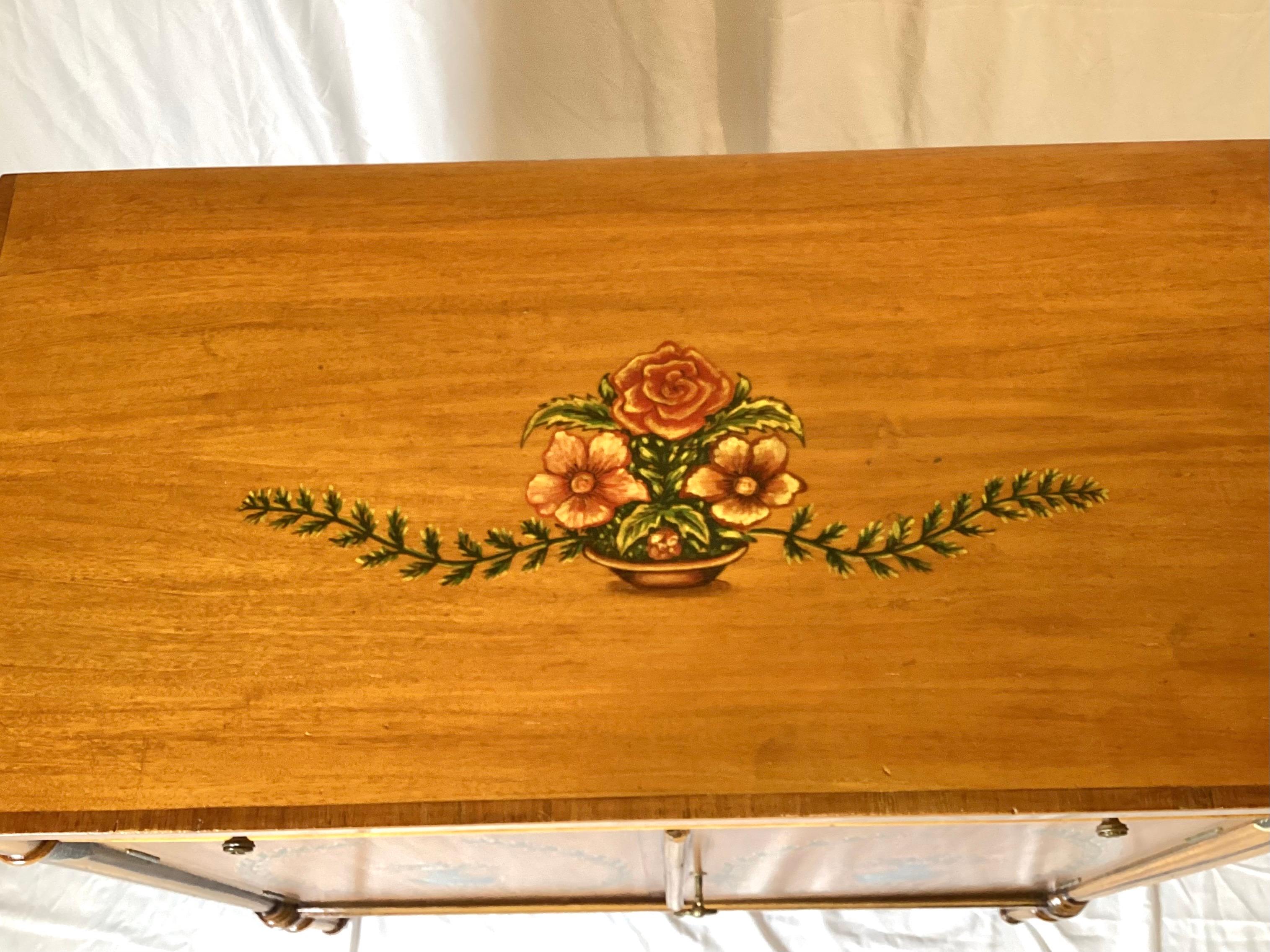 An elegant hand painted Adam style cabinet with one upper drawer above two doors with concealed shelf.  The classic Adam form with a light maple and satinwood with hand painted Adam style decoration.  34.5 inches high, 33 inches wide, 16 inches