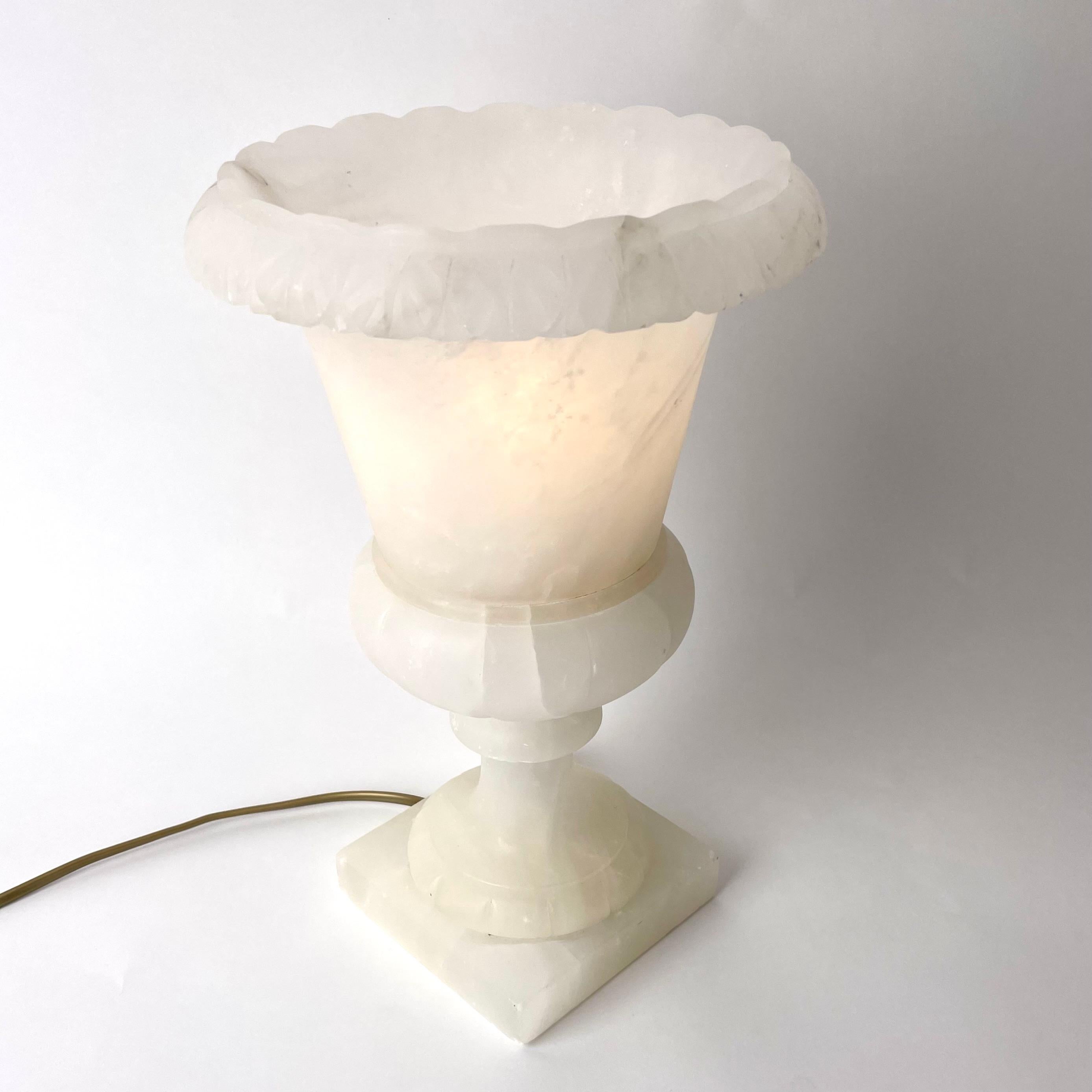 An Elegant and Refined Alabaster Table Lamp in shape of Classical Urn, most probably Early 20th Century.

This charming table lamp holds the light bulb inside the alabaster urn, meaning that the light is filtered beautifully through the material