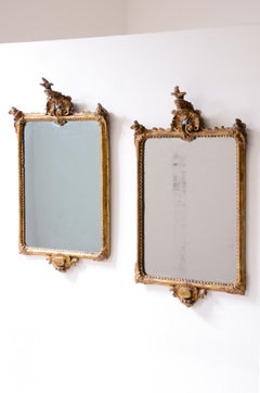 Elegant and refined pair of antiques carved and gilded wood mirrors