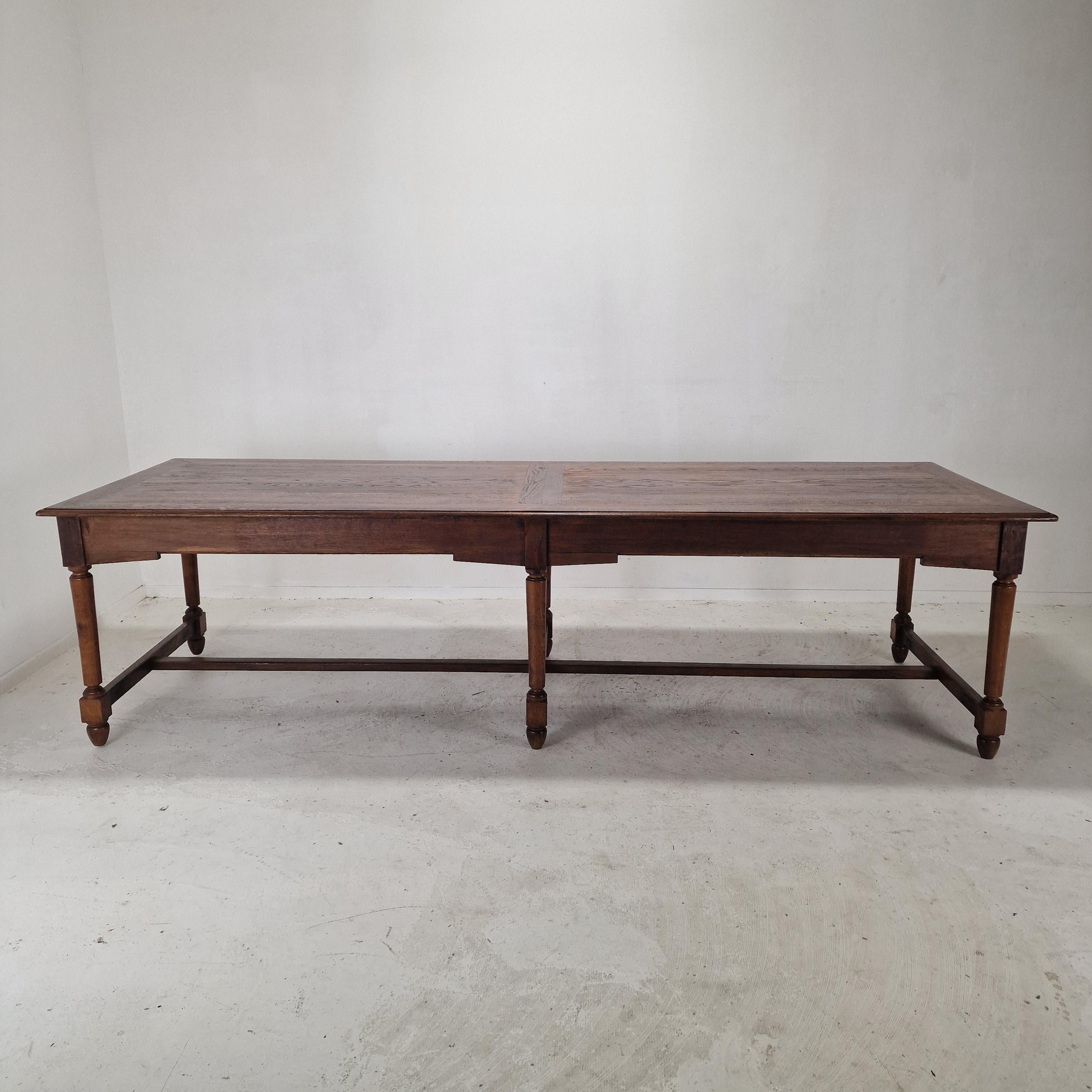 This striking 19th-century wooden dining table originates from a European monastery and exudes timeless character and craftsmanship. 
Featuring an impressive length and supported by six sturdy legs, the table offers both visual balance and