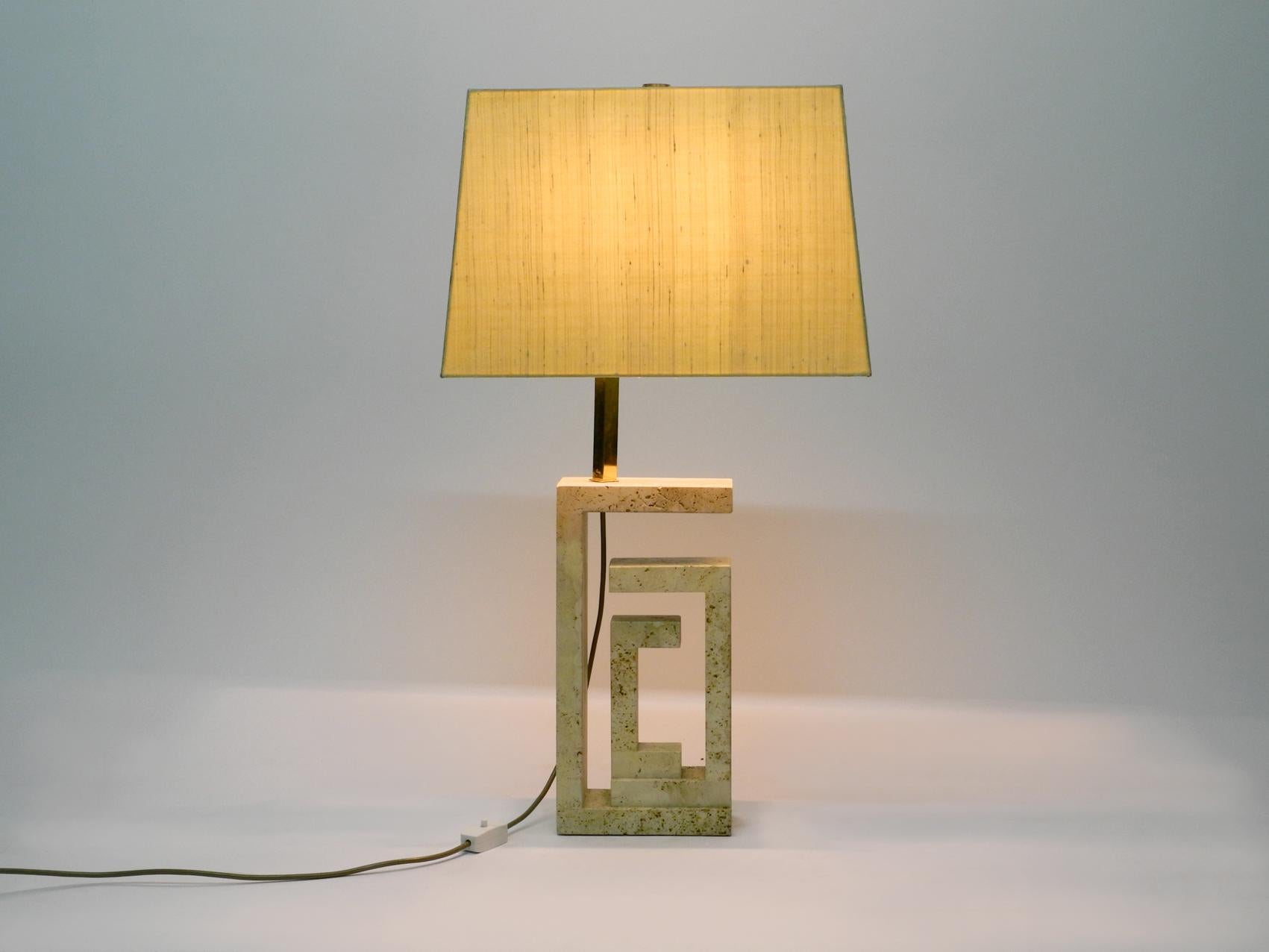 Elegant and very large sculptural Italian table lamp with a base made of travertine. Attributed to Fratelli Mannelli. Made in the 1960s. Beautiful very elaborate design. No damages to the travertine. Great patina. Large shade made of wild silk