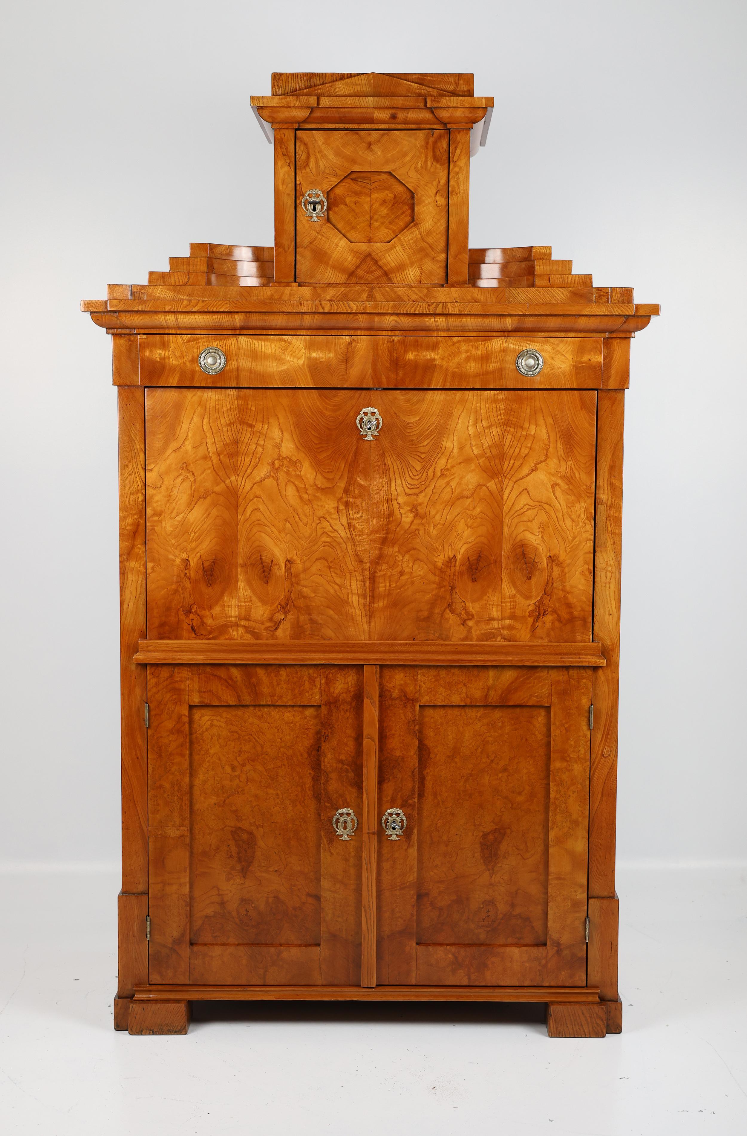 Elegant Antique Ash Veneer Secretary Desk

This exquisite original secretary desk, crafted in fine ash veneer, is a true testament to timeless elegance and expert craftsmanship. Its sophisticated design features a small top with a gable, flanked by